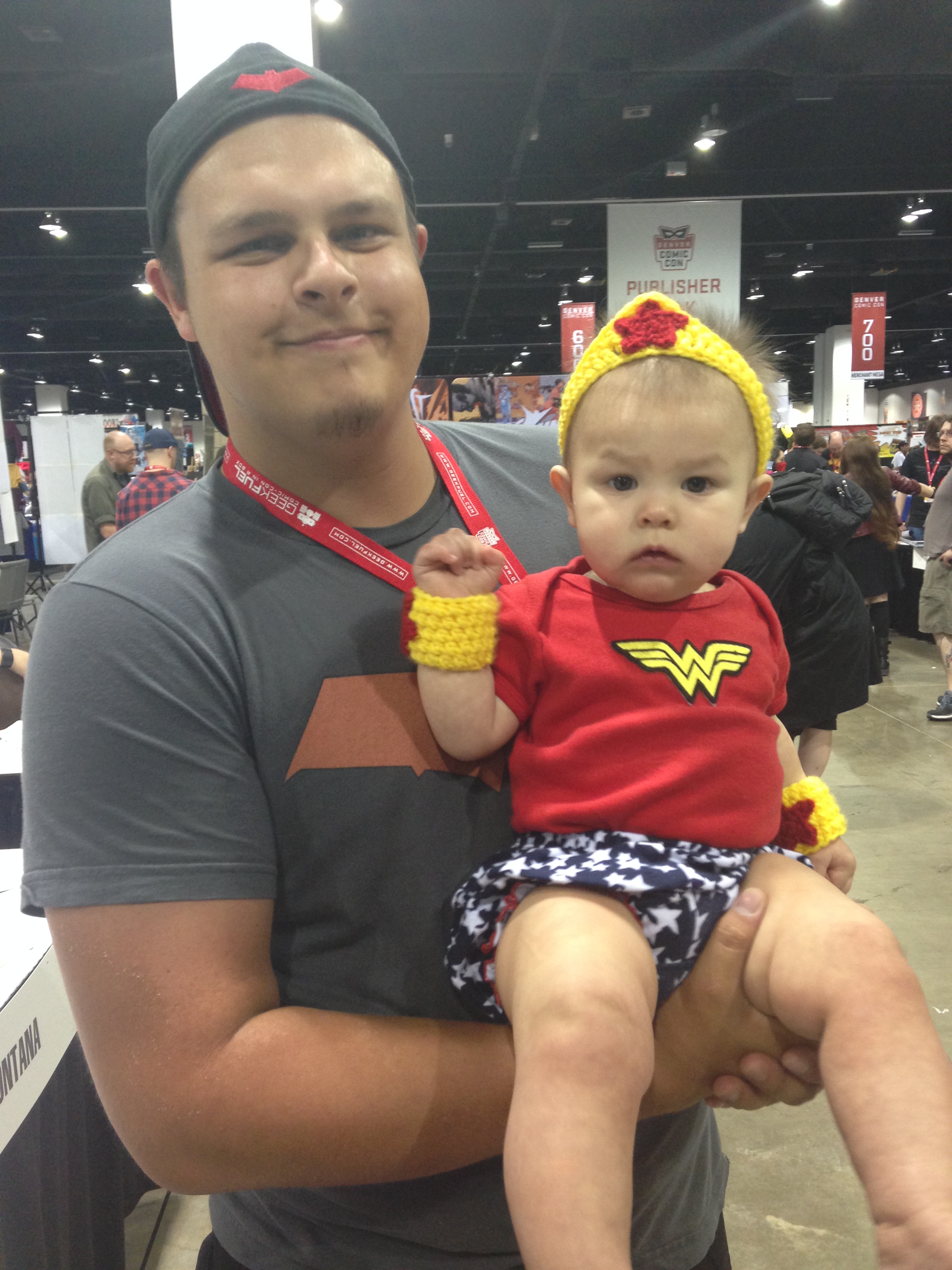 She ruled the con as tiny Wonder Woman! Here is Annabella with her daddy.