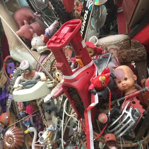 The Cathedral of Junk, where baby dolls, piggy banks, and flamingos coexist