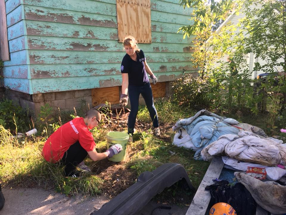 Ecolibrium3 VISTA Corps members completing a joint day of service to clean an abandoned property in Duluth, MN.