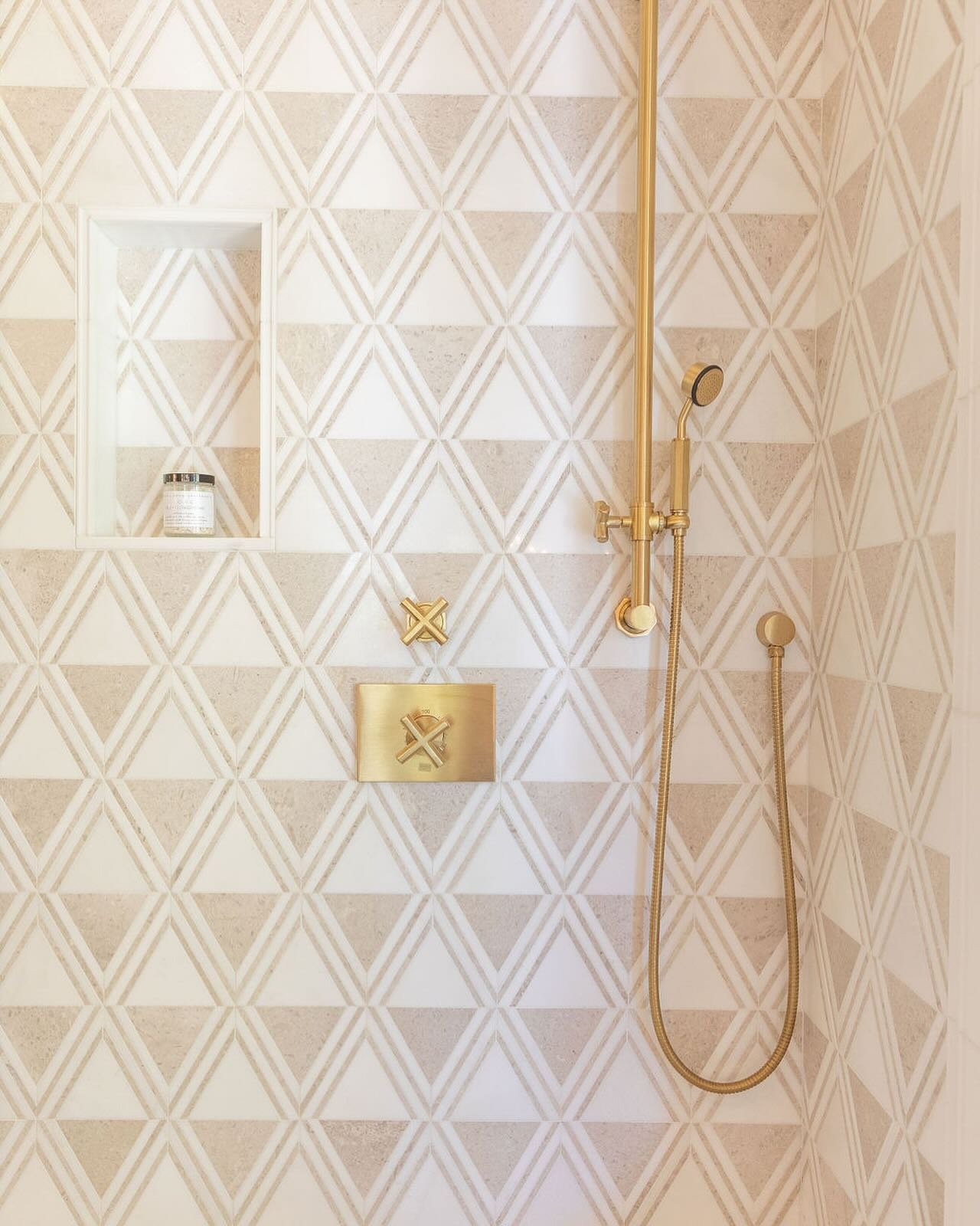 Sometimes the smallest details have the biggest impact. #interiordesign #biographicaldesign #bathroomdesign #shower #marble #mosaic #goldhardware