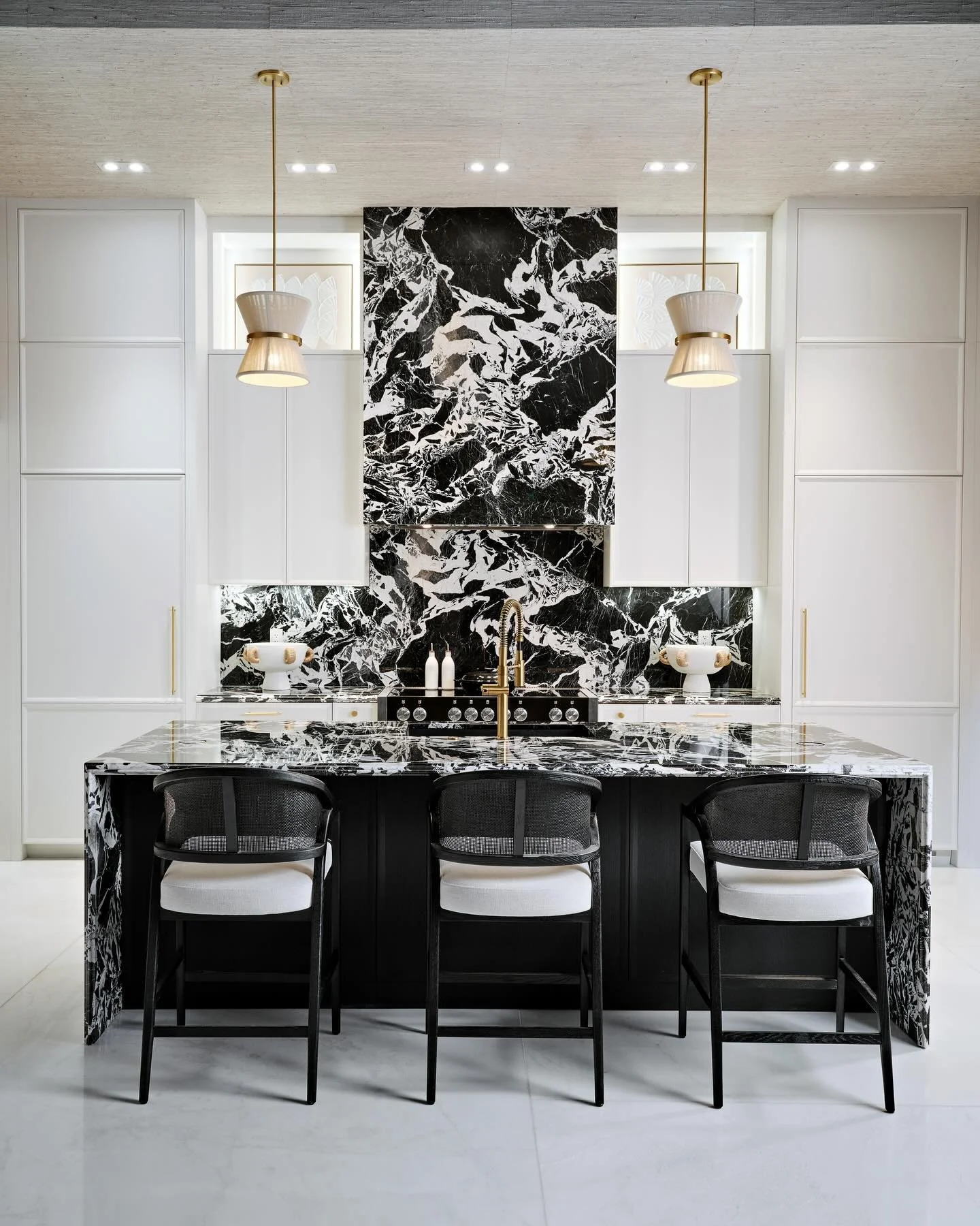 A Symphony in Black and Balance 🖤
This kitchen celebrates the timeless art of symmetry &mdash; every line, proportion, and reflection intentionally placed to create harmony. The bold black marble anchors the space with gravitas, while polished surfa
