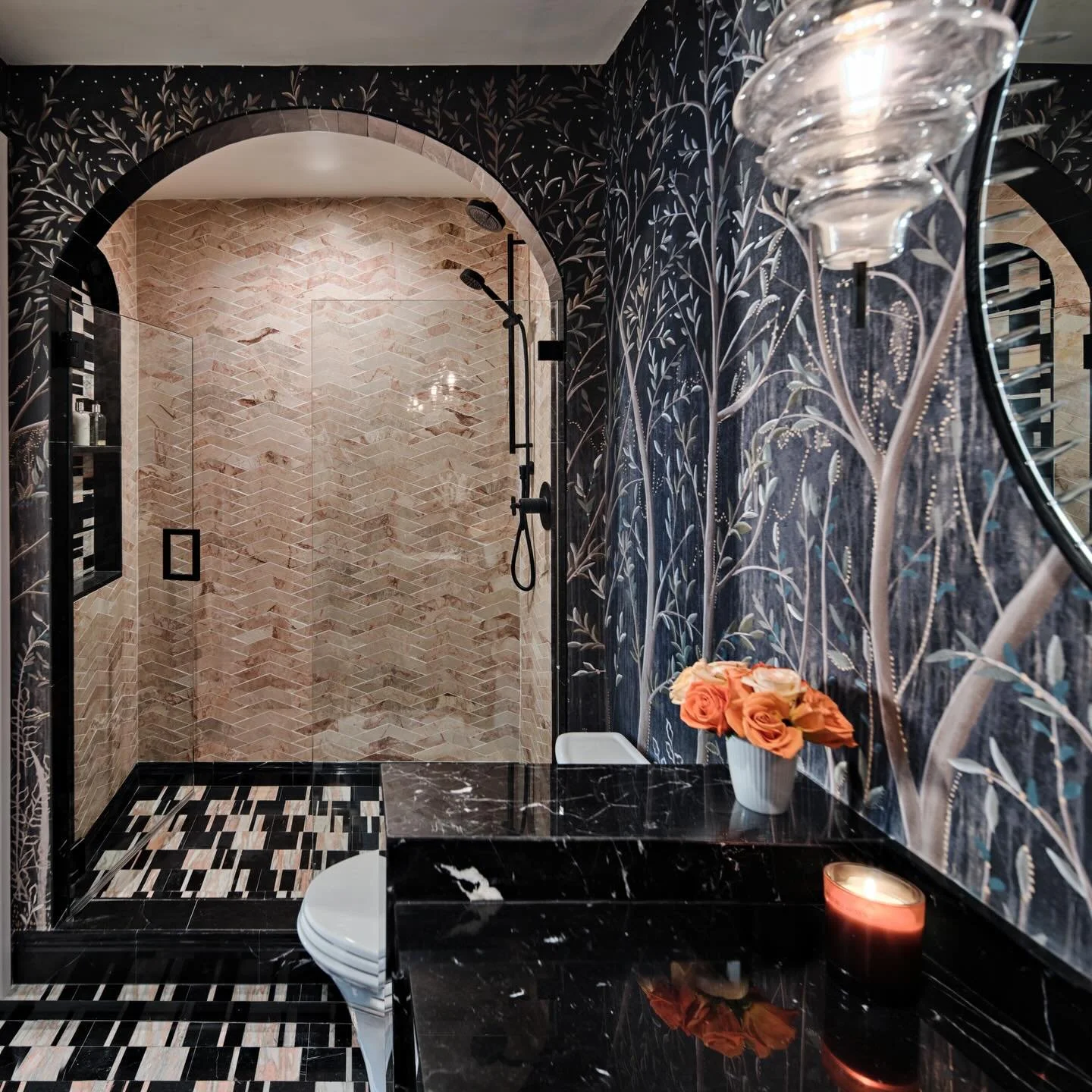 Step into a midnight enchanted forest. 🌙

This bathroom was designed to feel like twilight under a dense canopy &mdash; wrapped in inky, botanical wallpaper, layered with rich marble mosaics, and anchored by moss-green cabinetry that feels both grou
