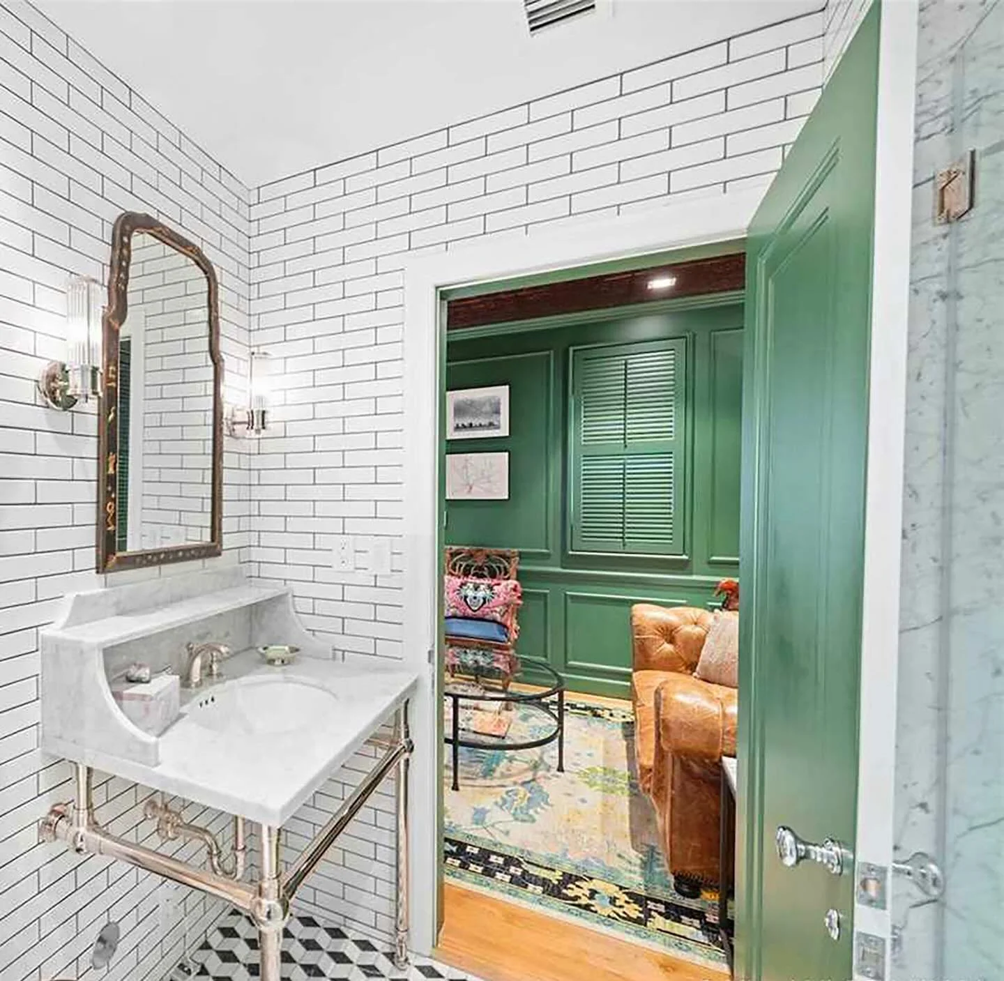 A doorway to color.
This crisp white bathroom sets the stage&mdash;then opens into a room drenched in high-gloss Kelly green lacquer. A moment of contrast, a shift in mood, a reminder that even the most restrained spaces can lead somewhere bold.

#bi
