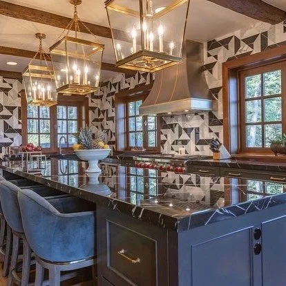 A ch&acirc;teau, reimagined.

This kitchen balances history with intention&mdash;ornate architectural bones meet a sharper, more contemporary point of view. Custom mosaic walls bring texture and artistry, set against warm wood beams and classic ch&ac