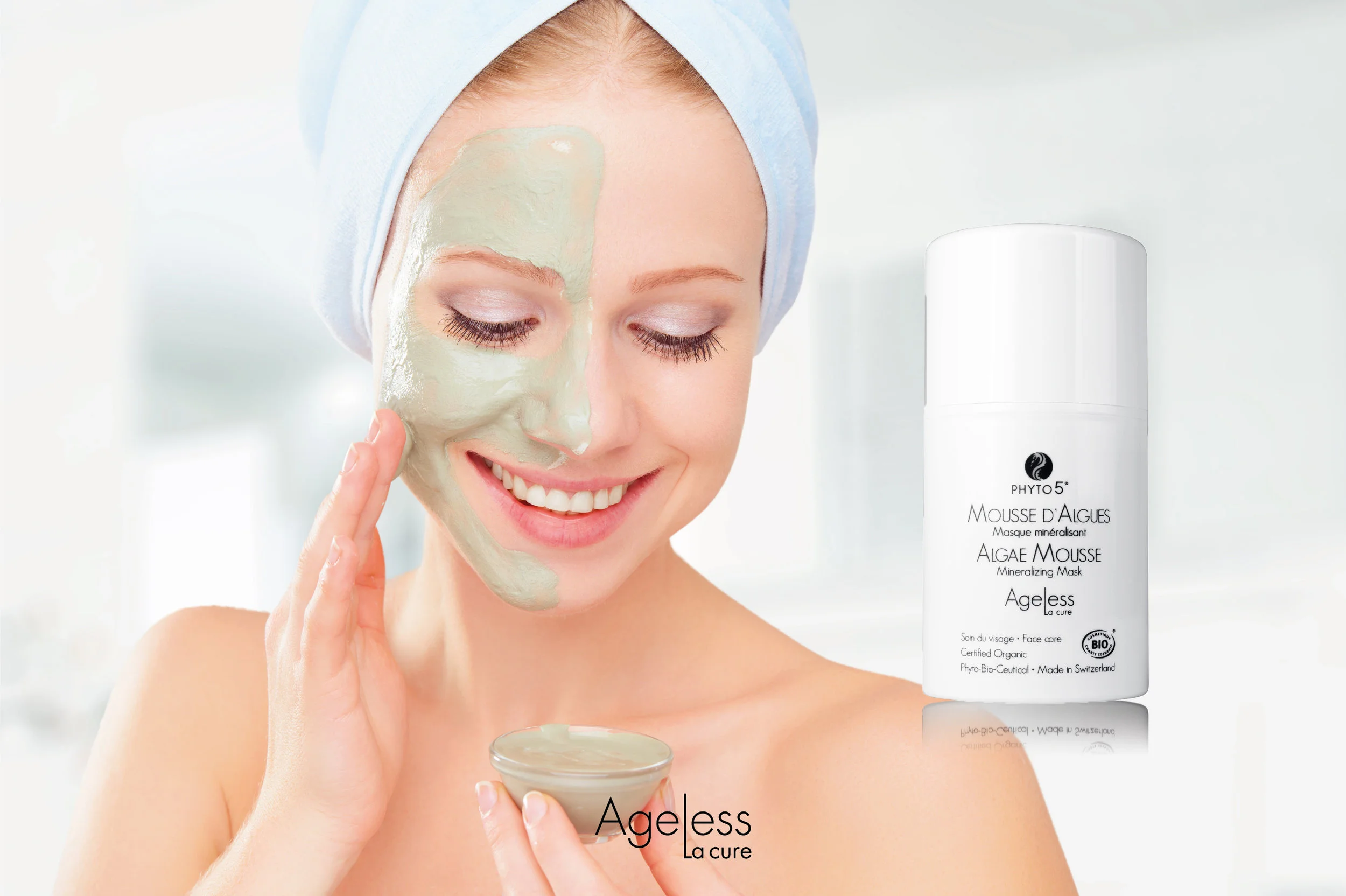 A woman enjoying Ageless La Cure Algae Mousse brushed onto one half of her face