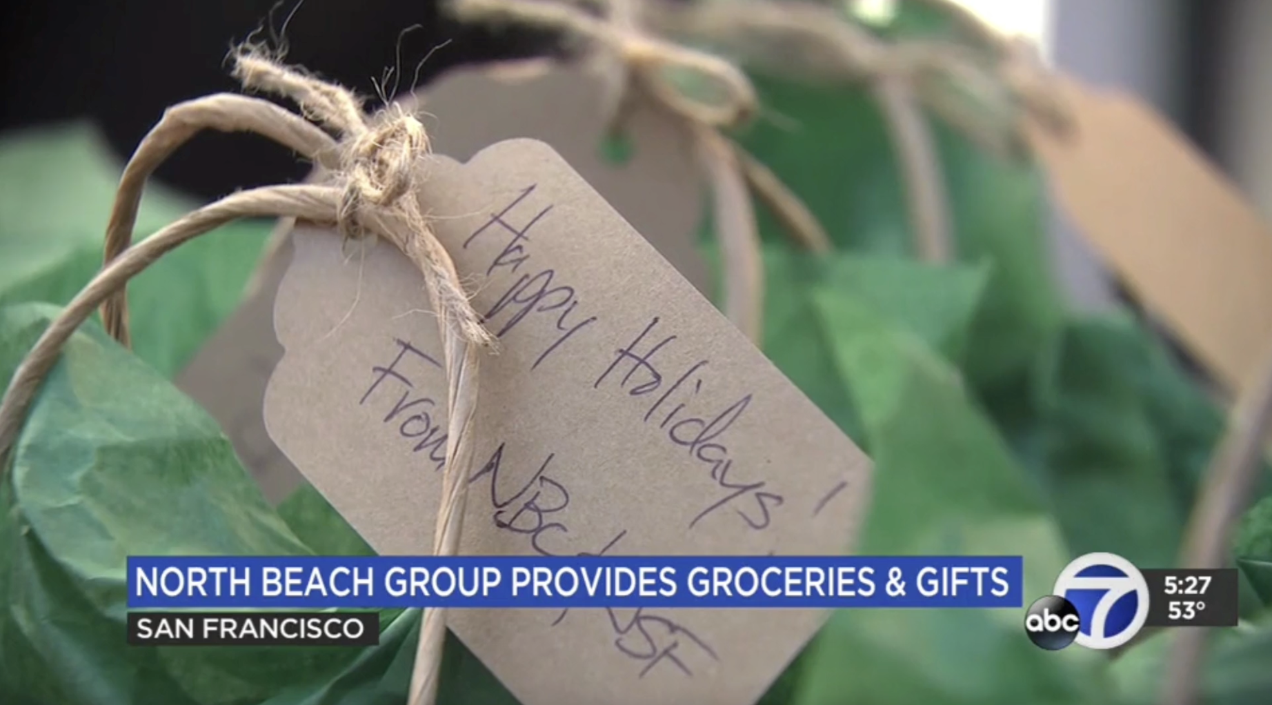 Tag attached to bag says Happy Holidays from North Beach Citiznes