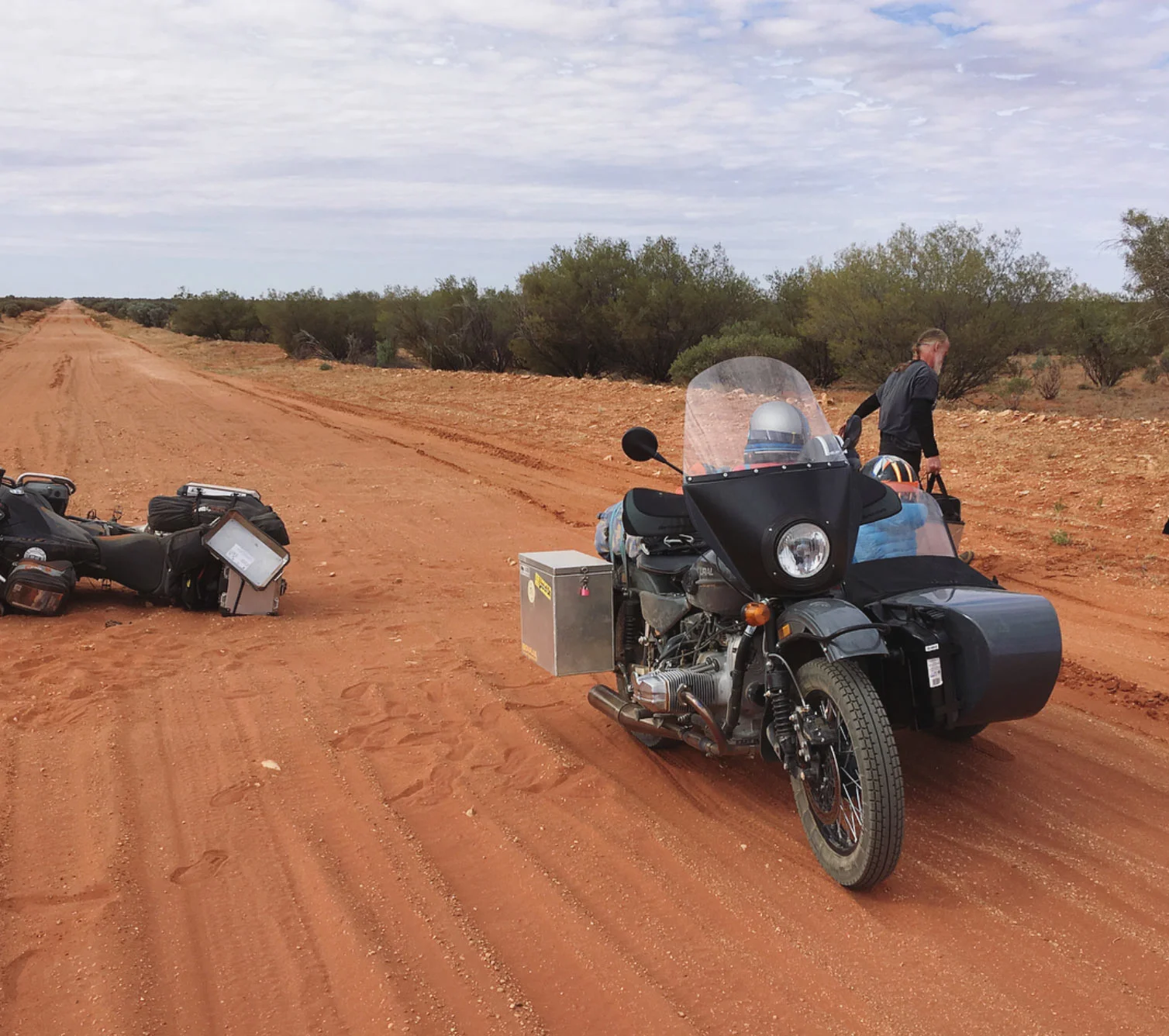 The family stopped to help this BMW rider who suffered a flat tire from a bent rim.