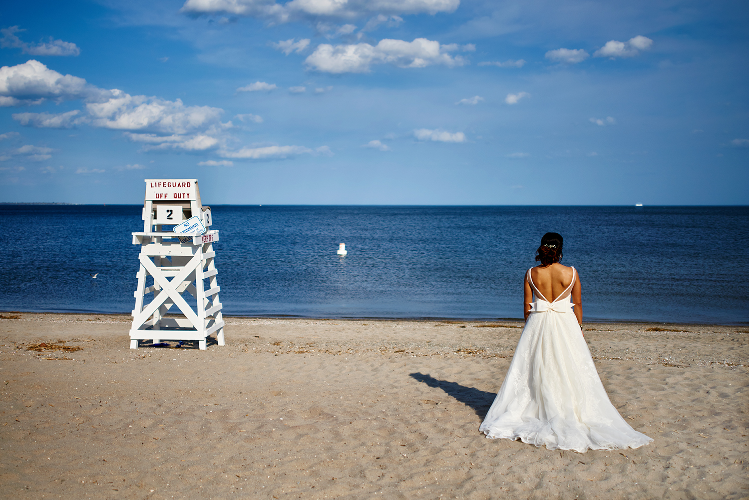Wedding party photos at Fairfield Beach in Fairfield, CT. Bride and groom at the beach, bridal New England beach portraits, and wedding party fun photos at the beach.