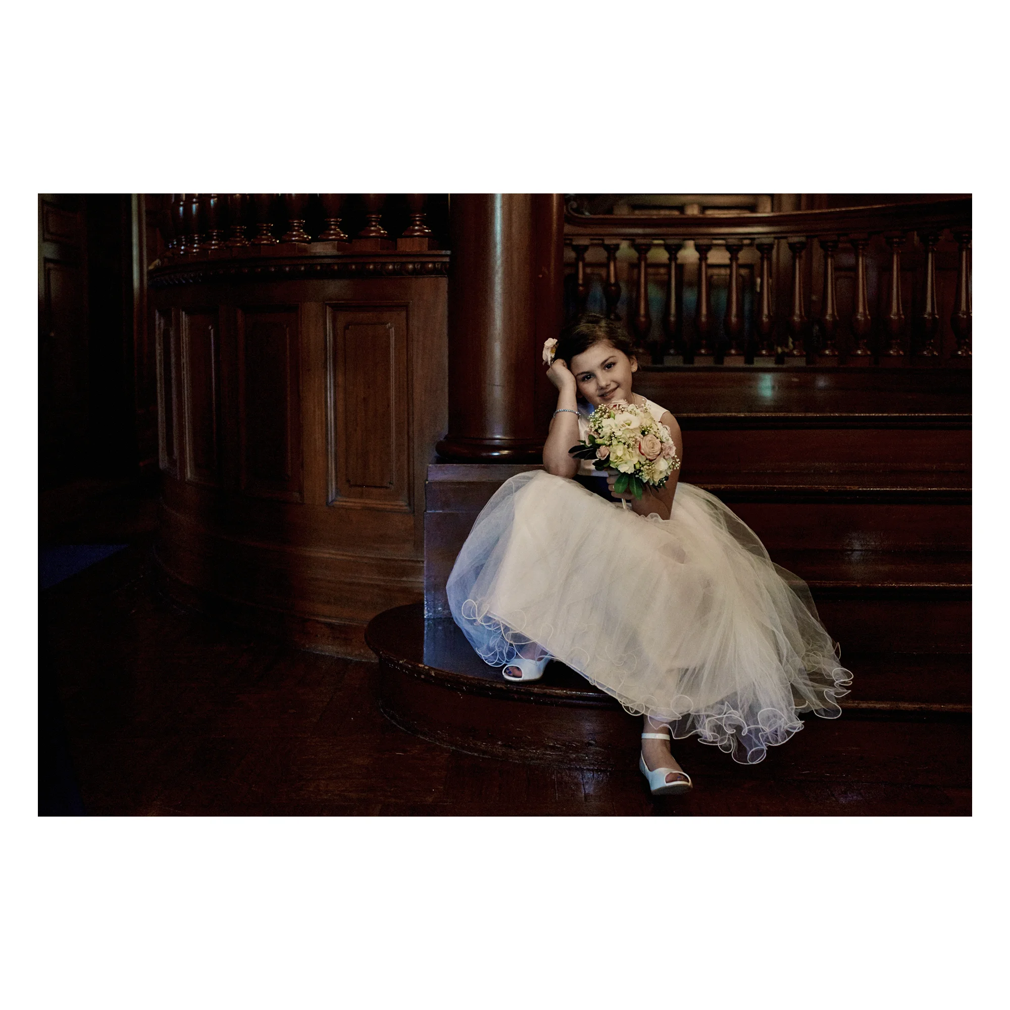 Flower girl on steps before wedding ceremony