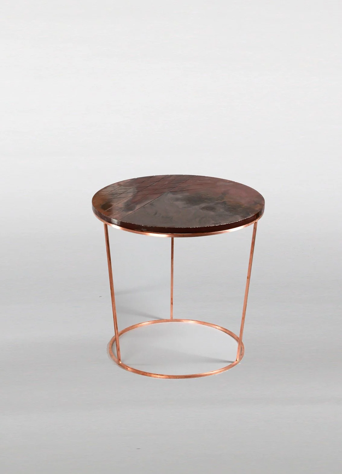 Round copper side table with a metal frame and a wooden top, front view.