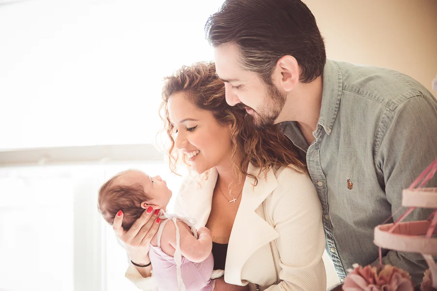 lifestyle photograph of baby girl with parents