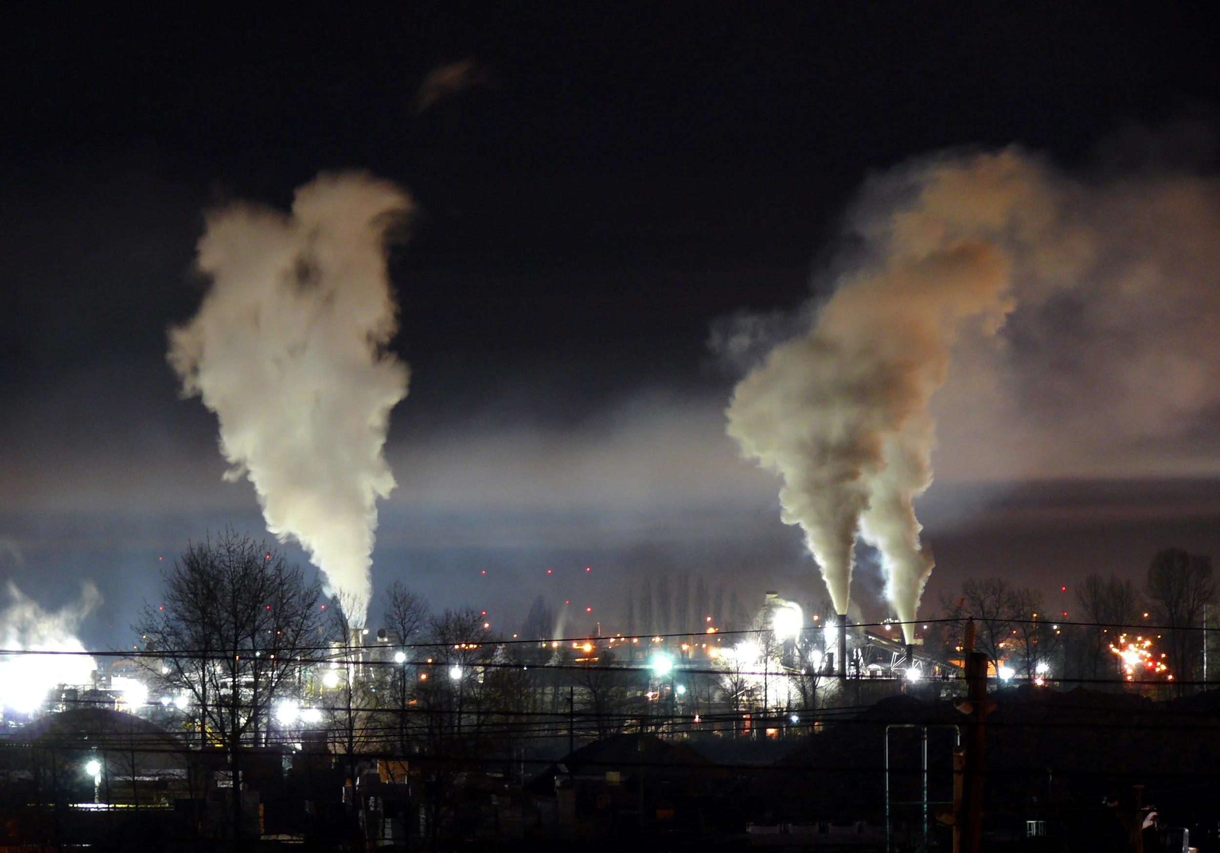 Companies that emit carbon dioxide are held to emissions requirements under carbon offset programs. If they cannot meet them by other means, they can make investments in carbon offset programs, like the wind farm below, that will "offset" their emissions and help them meet their emissions reduction goals. Photo by Gavin Schaefer via Wikimedia Commons
