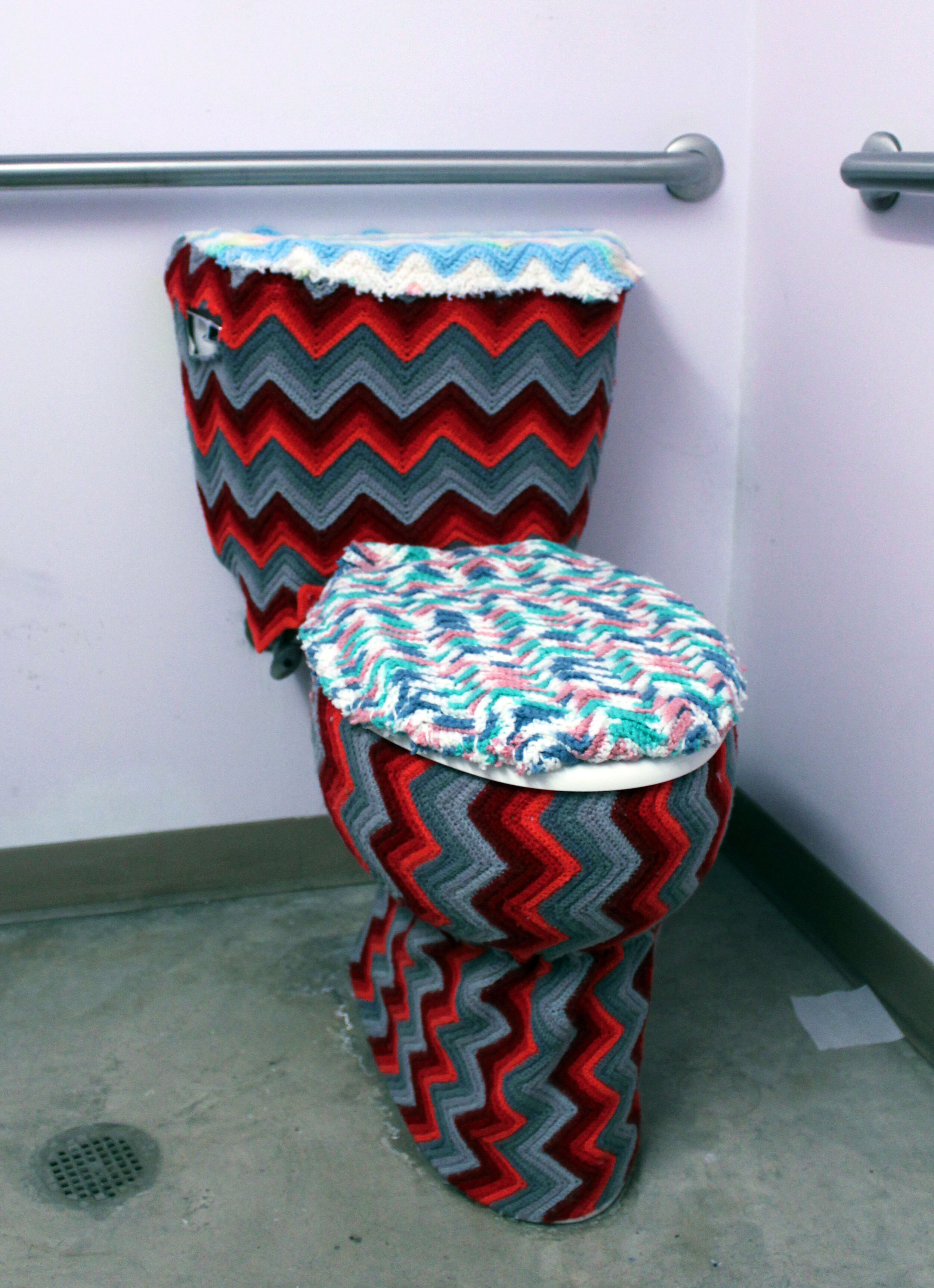  shared studio space toilets were “yarn bombed” with thrifted afghans for 2 weeks  