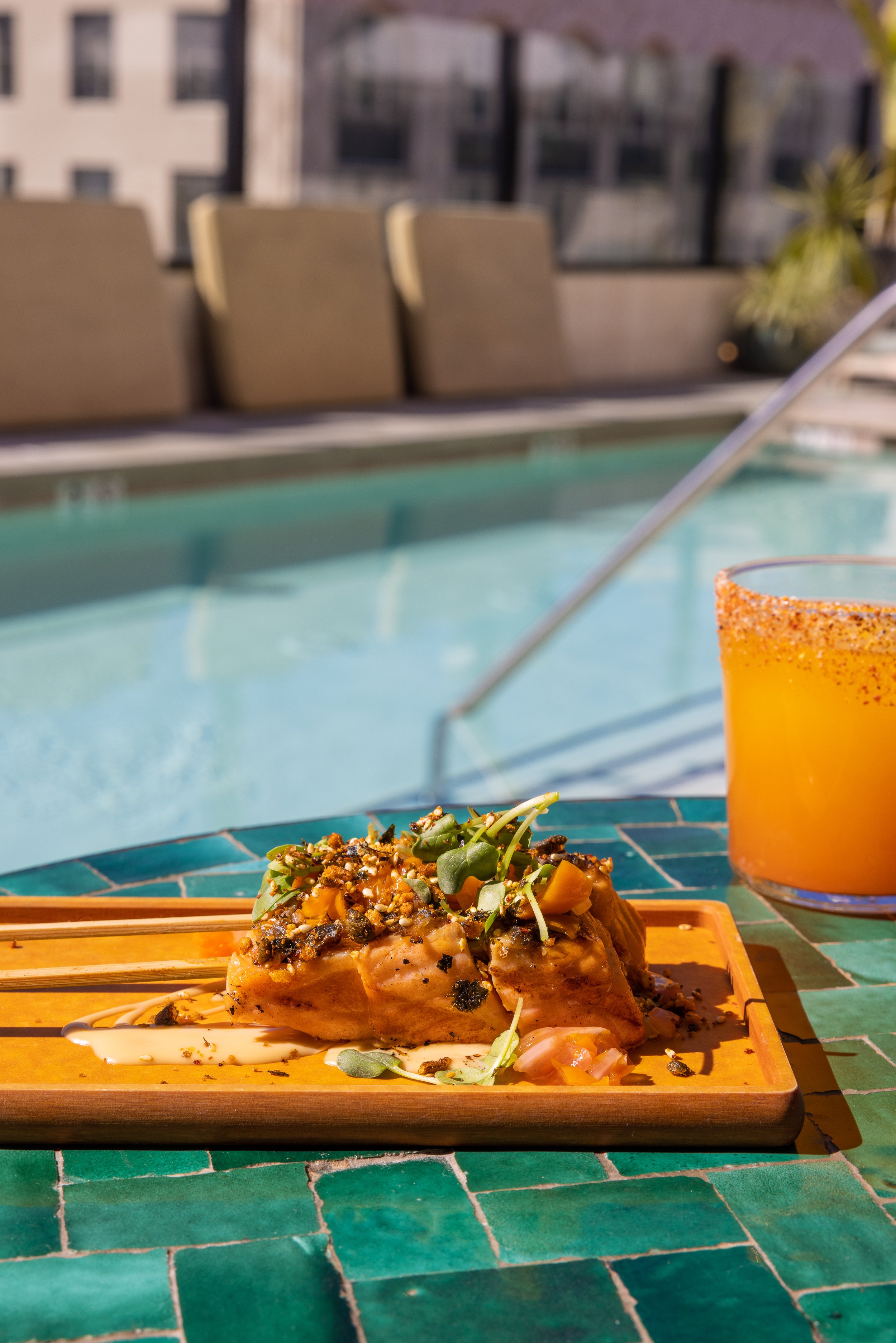  Cabra LA -  plate of skewers and a cocktail by the pool 
