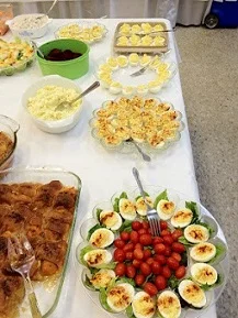 Take note: five platters of deviled eggs on this table.