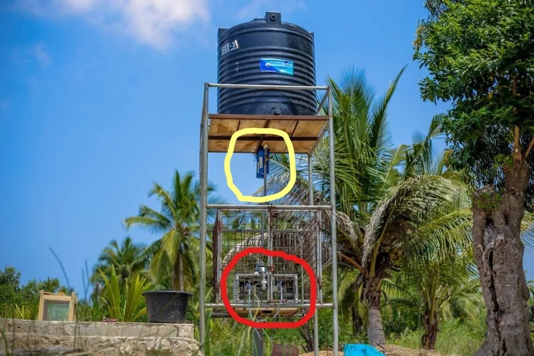 NUF500 device – Dirty water pumped up to black tank by a very small gasoline pump; when the valve of the device (red circle) is opened the dirty water flows out of the black tank through two prefilters to reduce silt (yellow circle), then through the device to produce pure water.
