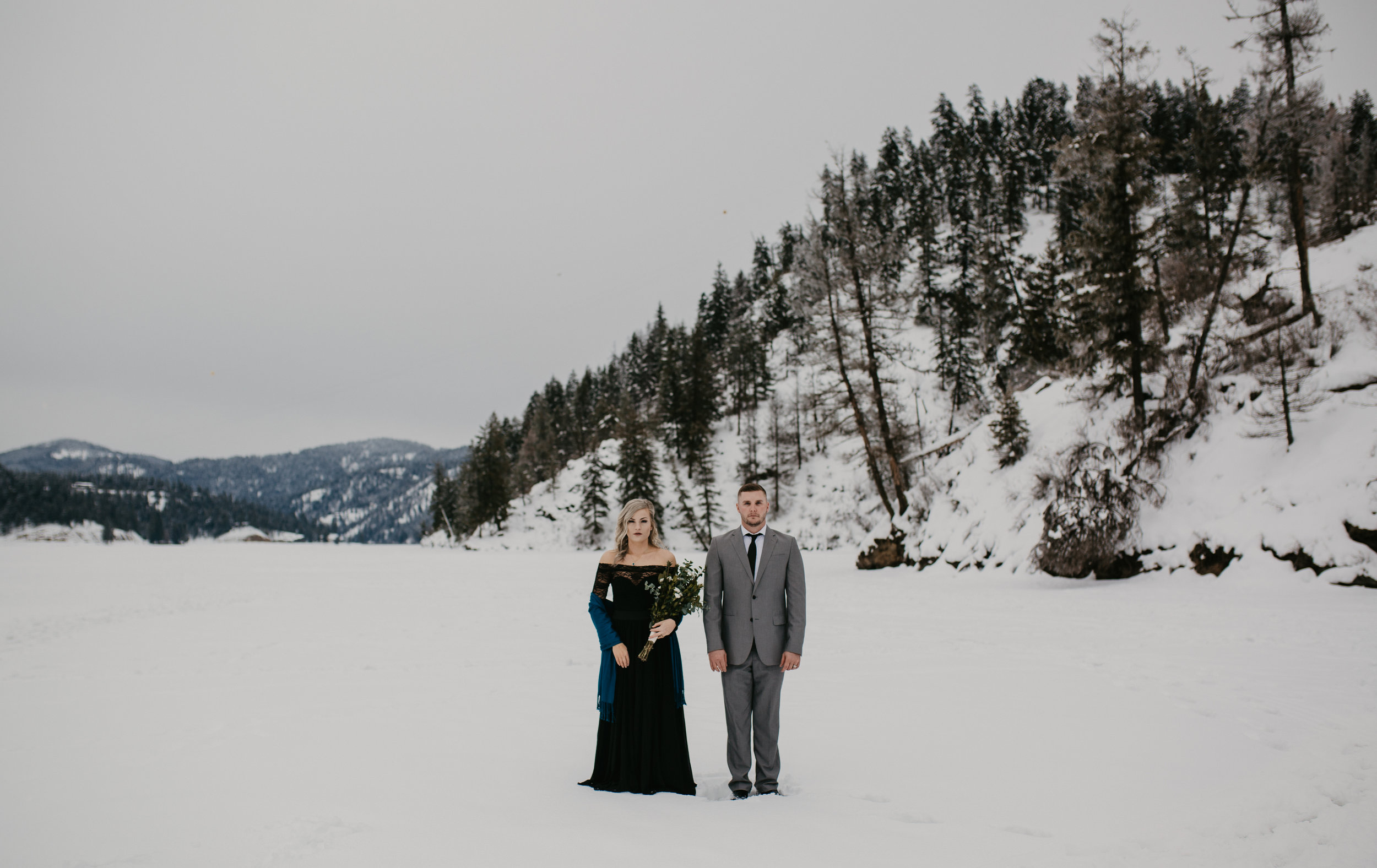  Bride and Groom standing on frozen lake during portrait session 