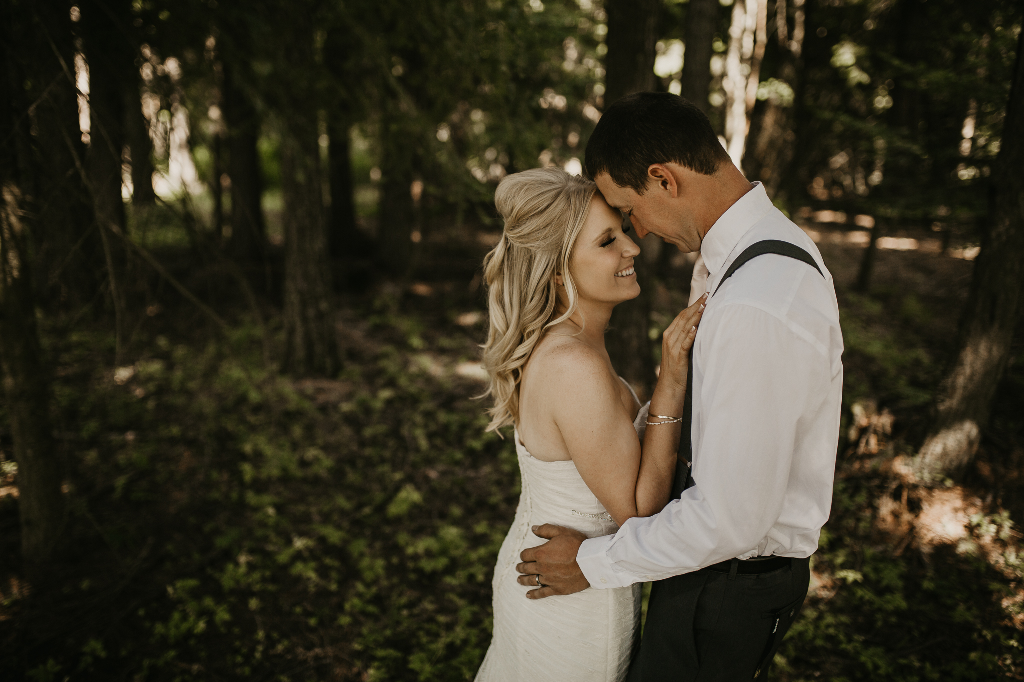  Bride and Groom snuggling in the forest during photoshoot 