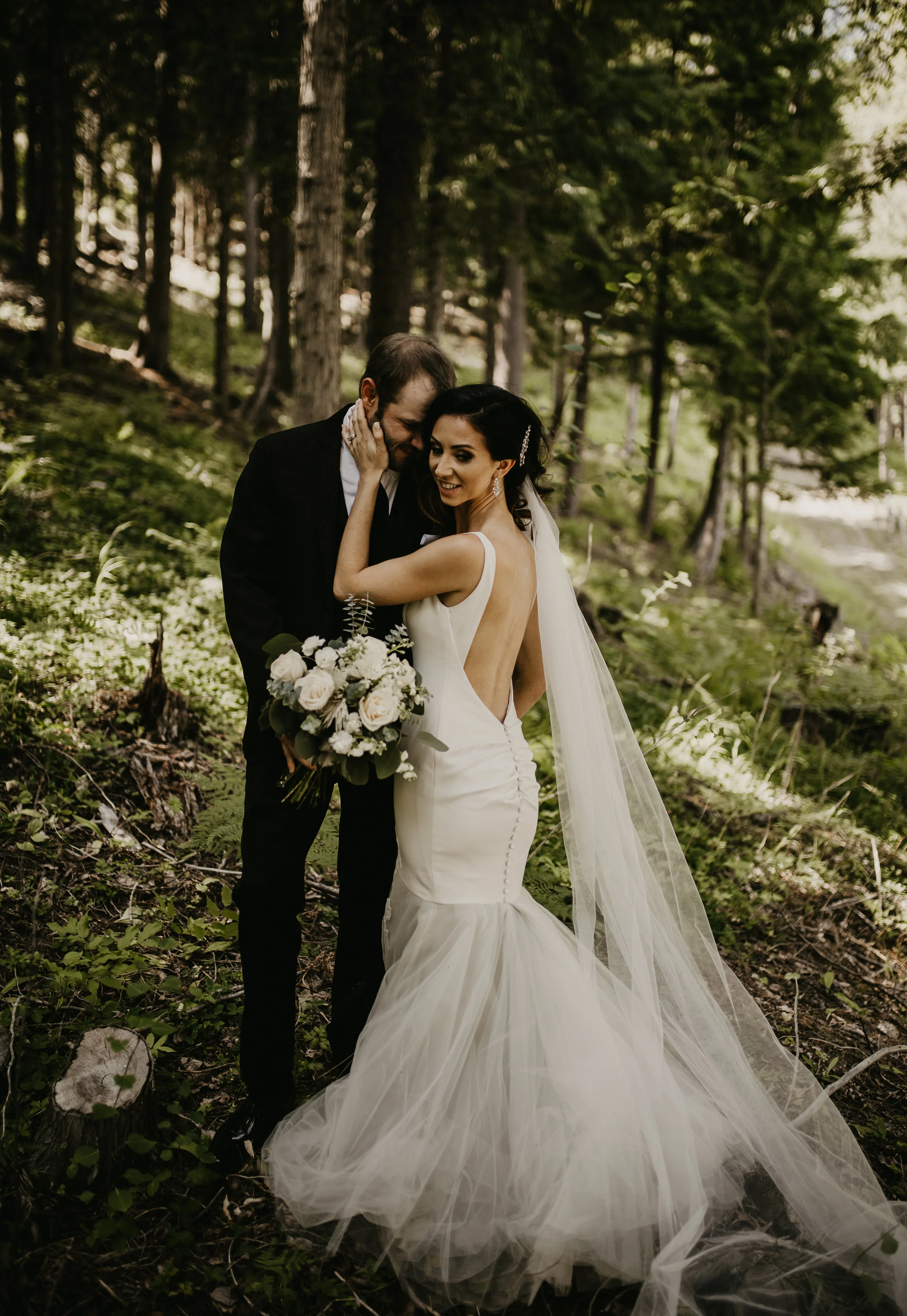 Bride and Groom standing in the forest during formal portraits