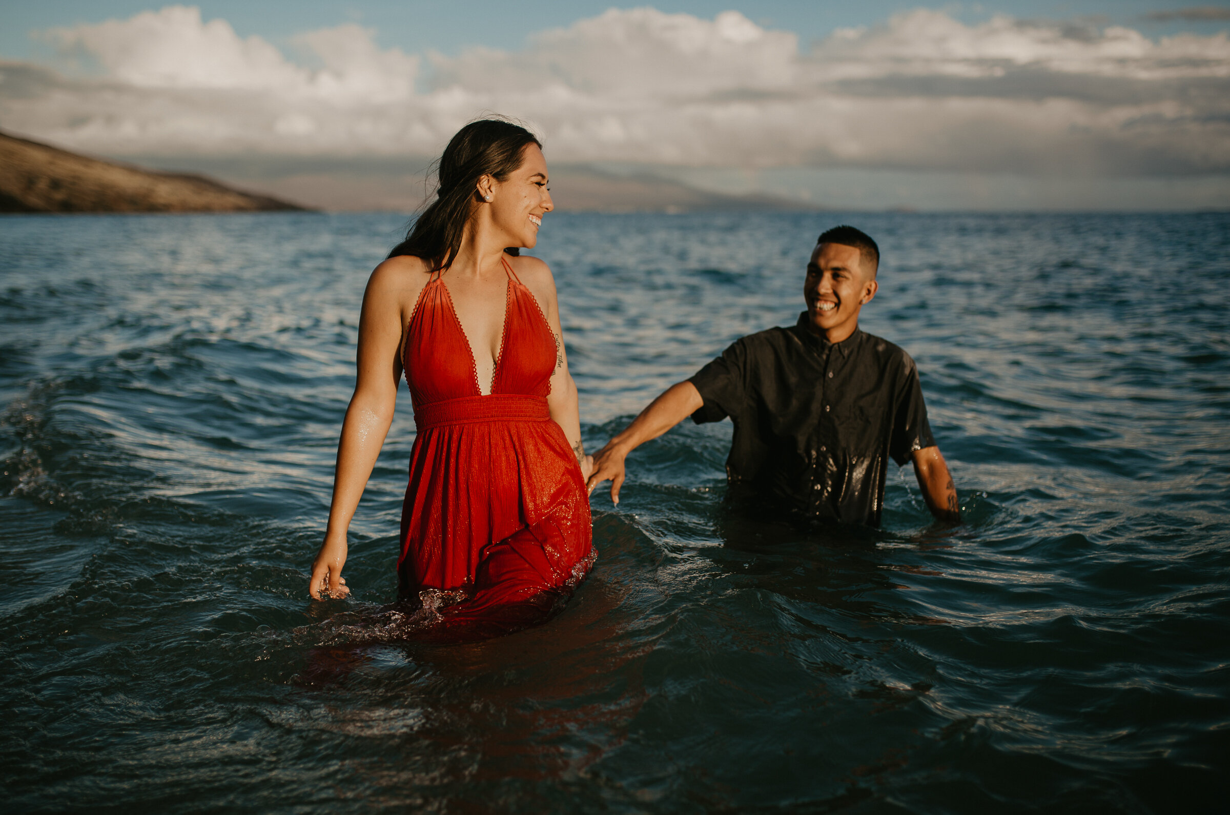  Couple playing in the water during engagement photoshoot 