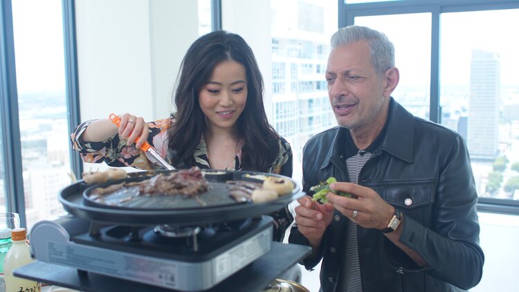 Episode 105 “BBQ”  Los Angeles, California - Jeff Goldblum (right) takes part in the viral rend of “mukbang”, eating Korean BBQ on camera with YouTube sensation, Stephanie Soo. (Photo: National Geographic/Susannah Wilkinson)