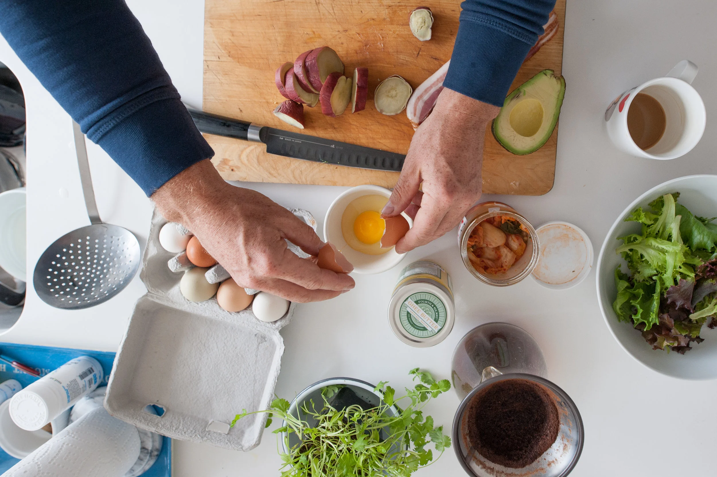 Seamus Mullen's kitchen counter as he prepares a meal with eggs and avocado