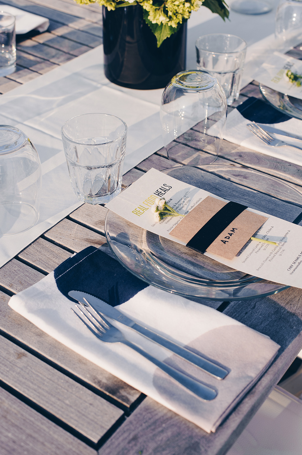 Rooftop dinner place setting with menu by Seamus Mullen