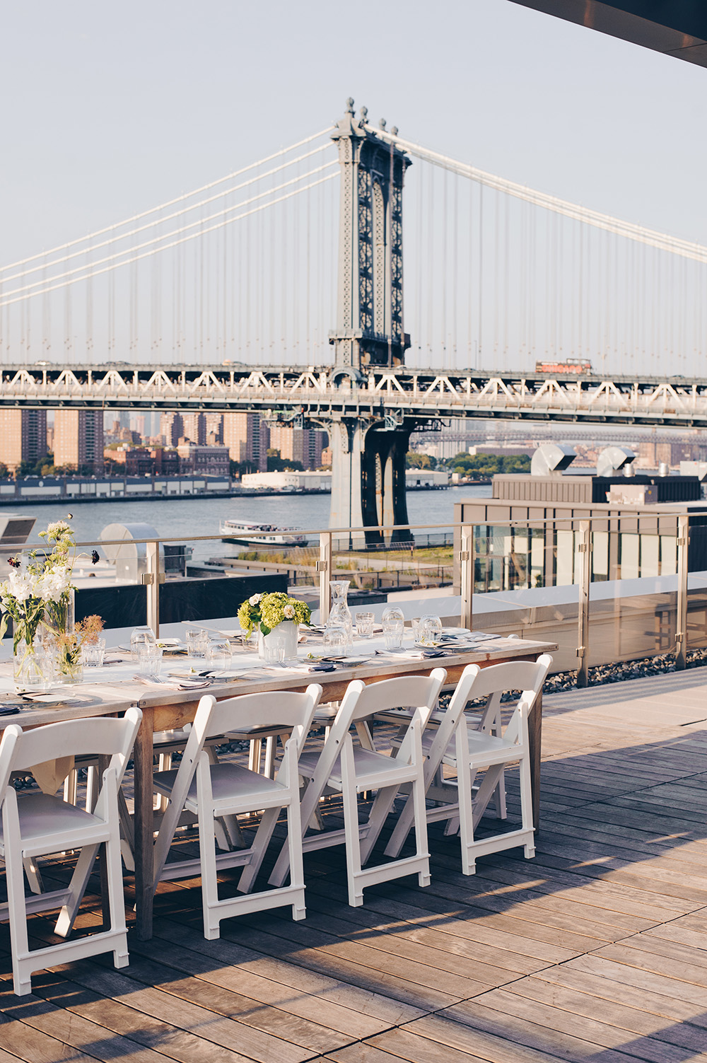 Rooftop dinner table with Williamsburg Bridge in background