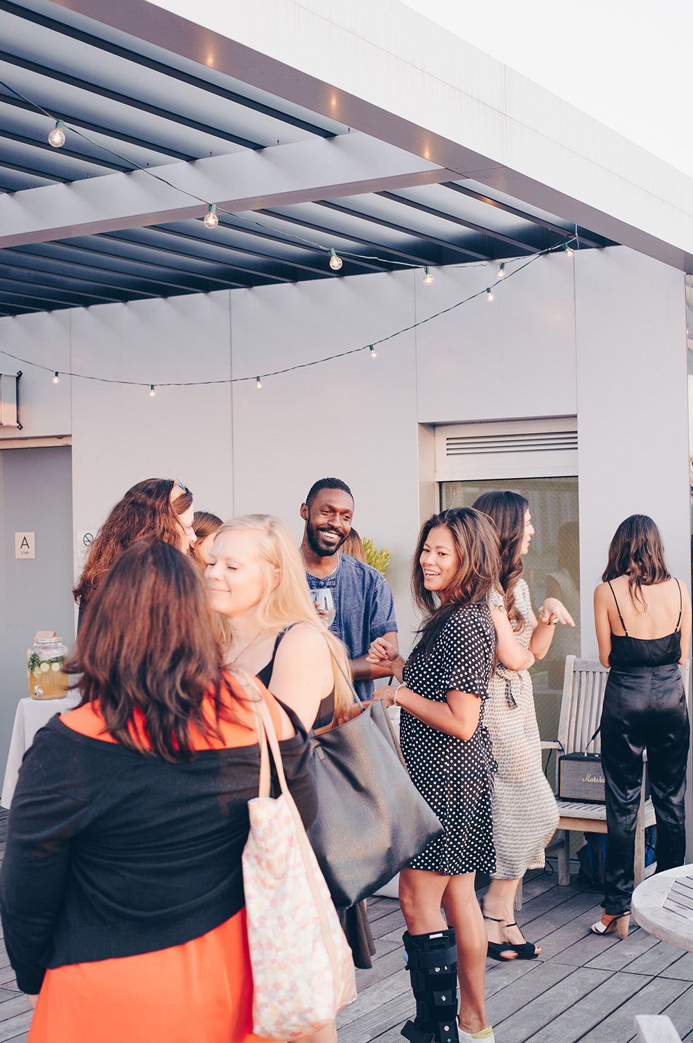 Guests mingle at rooftop dinner celebrating Seamus Mullen's book Real Food Heals