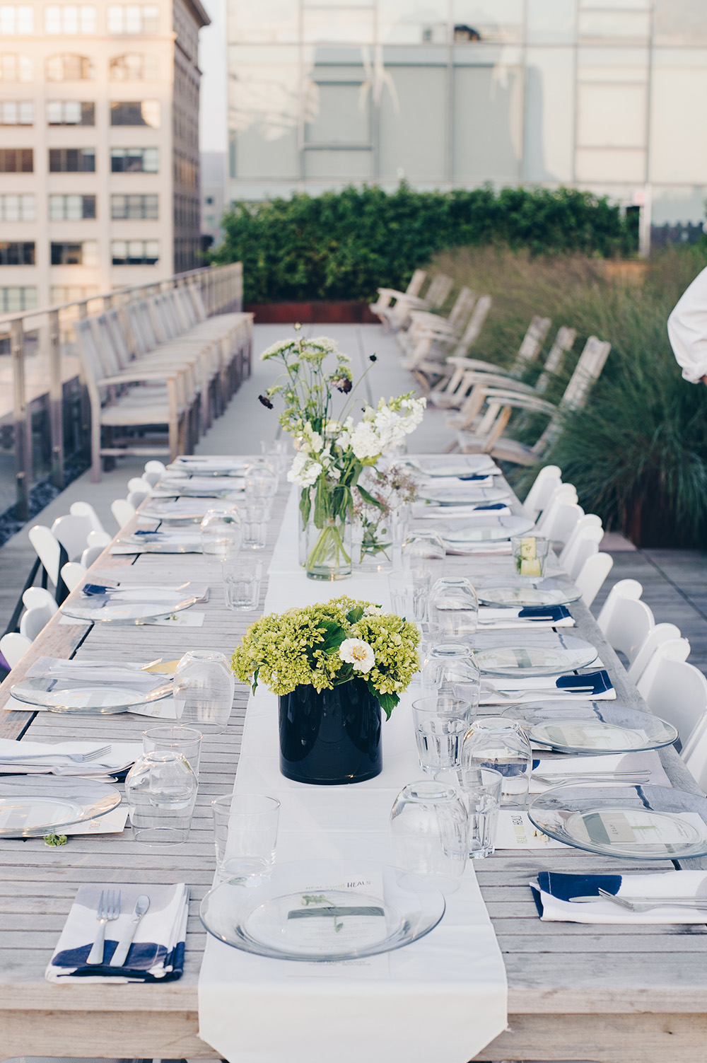 Dinner on the Roof table setting with wild flower centerpieces