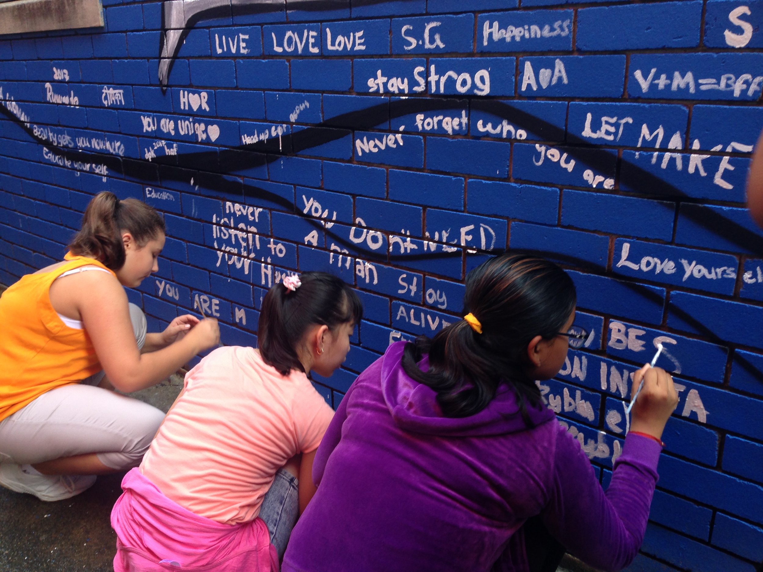 Young "artivists" from Liverpool Girls contributing to the community mural.