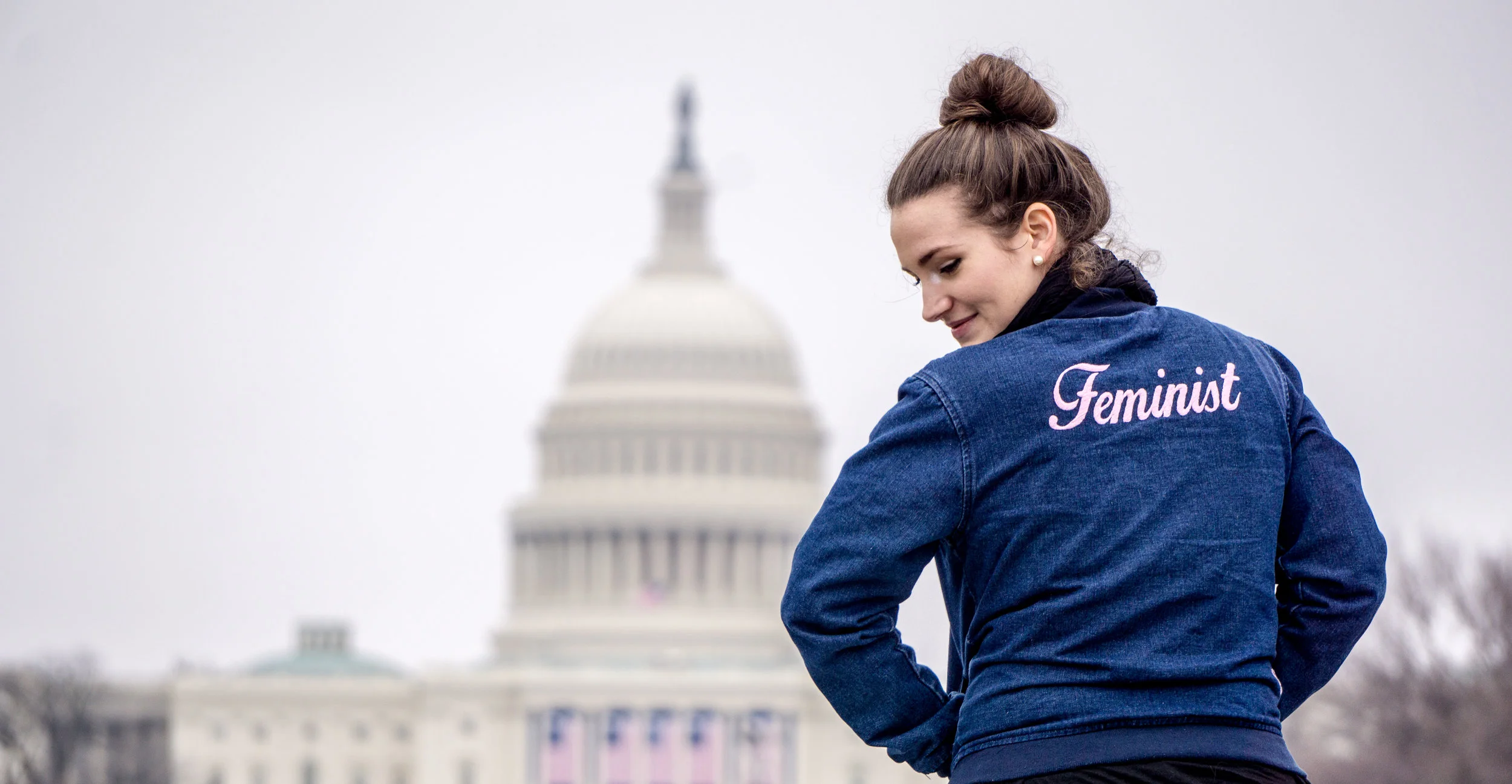  A young woman defies the capitol building during the Women's March on Washington.&nbsp; 