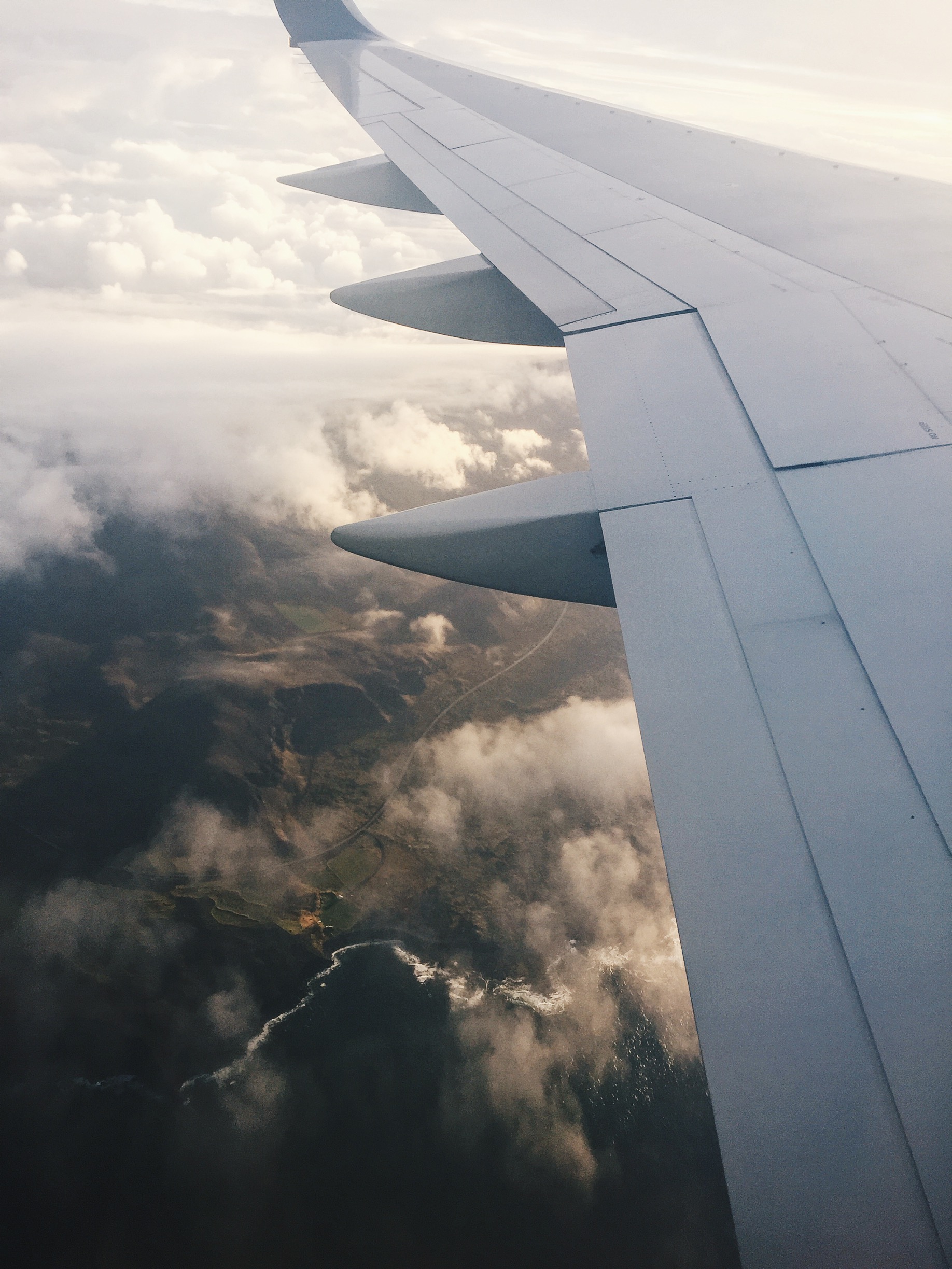 Iceland revealing itself after descending through the clouds.