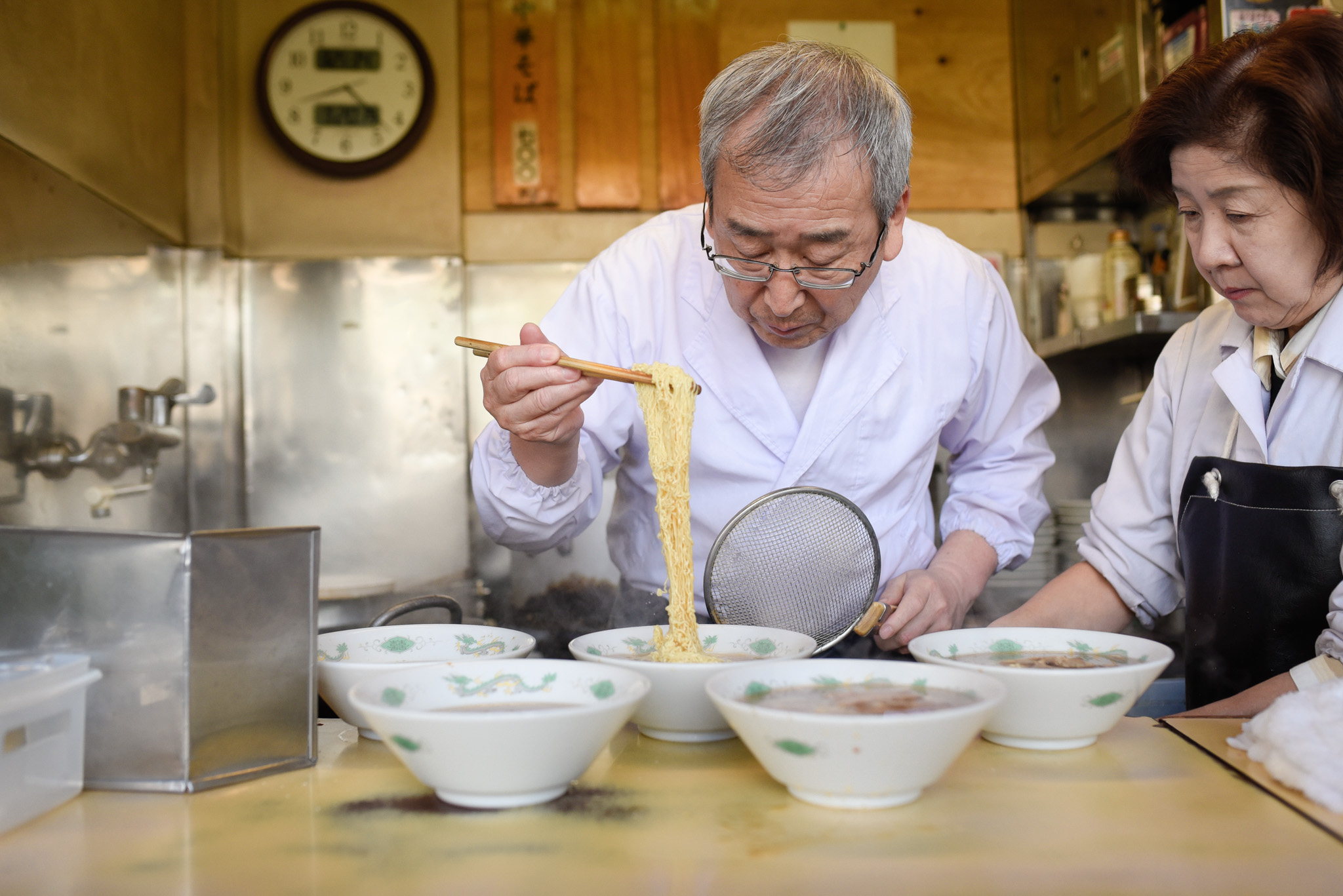 Ramen Master carefully placing the noodles in the bowl