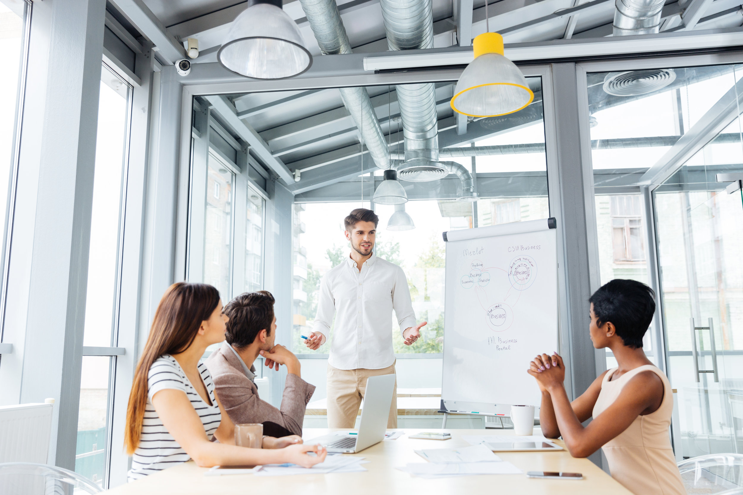 graphicstock-young-businessman-making-presentation-to-colleagues-on-the-meeting-in-office_BuGY5XQr2g.jpg