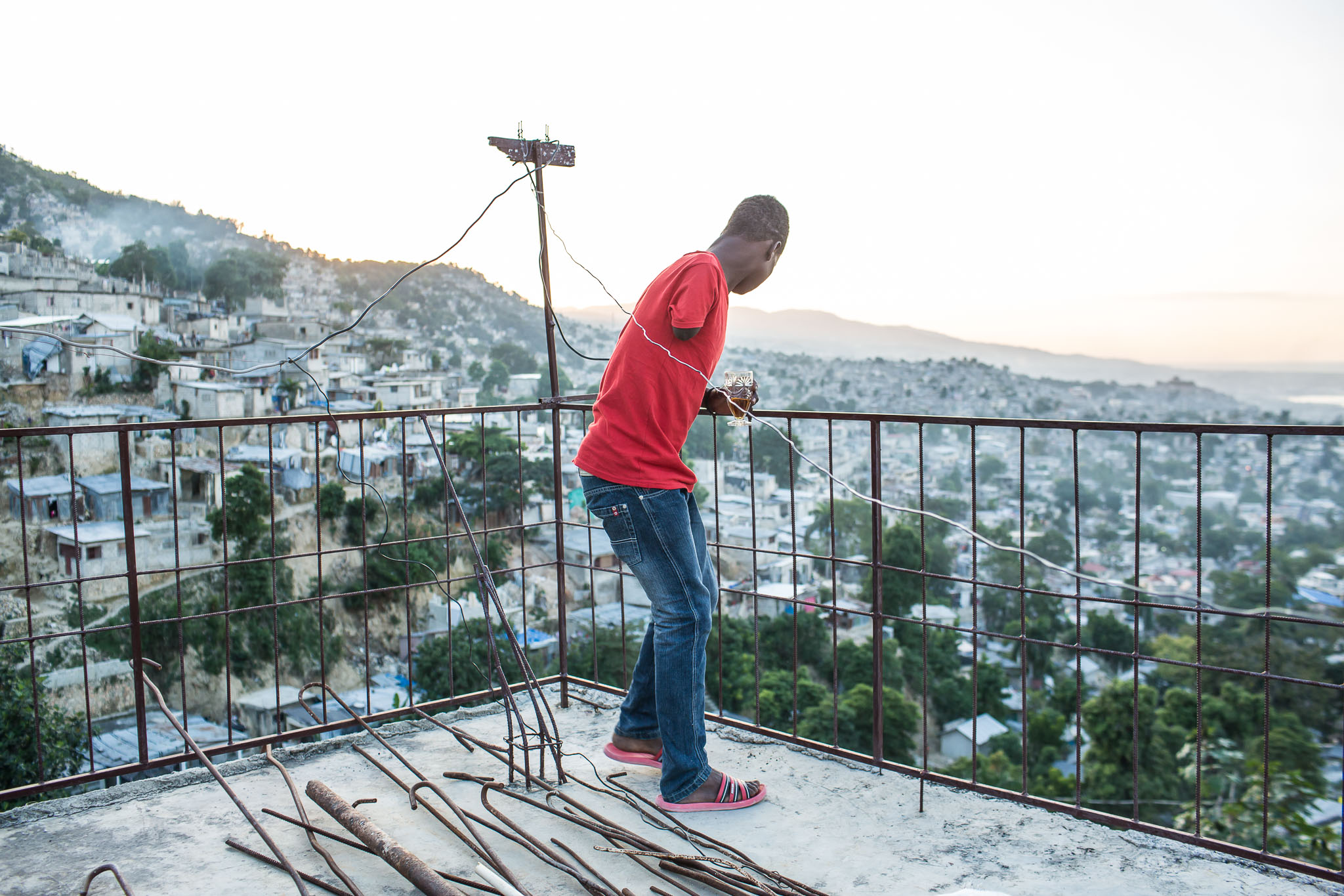  John Legagneuk looks over the Tapis Rouge neighborhood at sunset on Friday, December 19, 2014 in Port-au-Prince, Haiti. Legagneuk lost his arm in a car accident in 2012. 