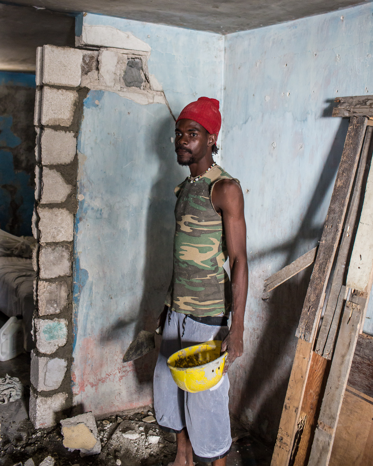  Steevenson Deus poses for a portrait while repairing his earthquake-damaged home on Thursday, December 18, 2014 in Port-au-Prince, Haiti. Fort National was among the hardest hit areas of Port-au-Prince in the 2010 earthquake, but rebuilding has been