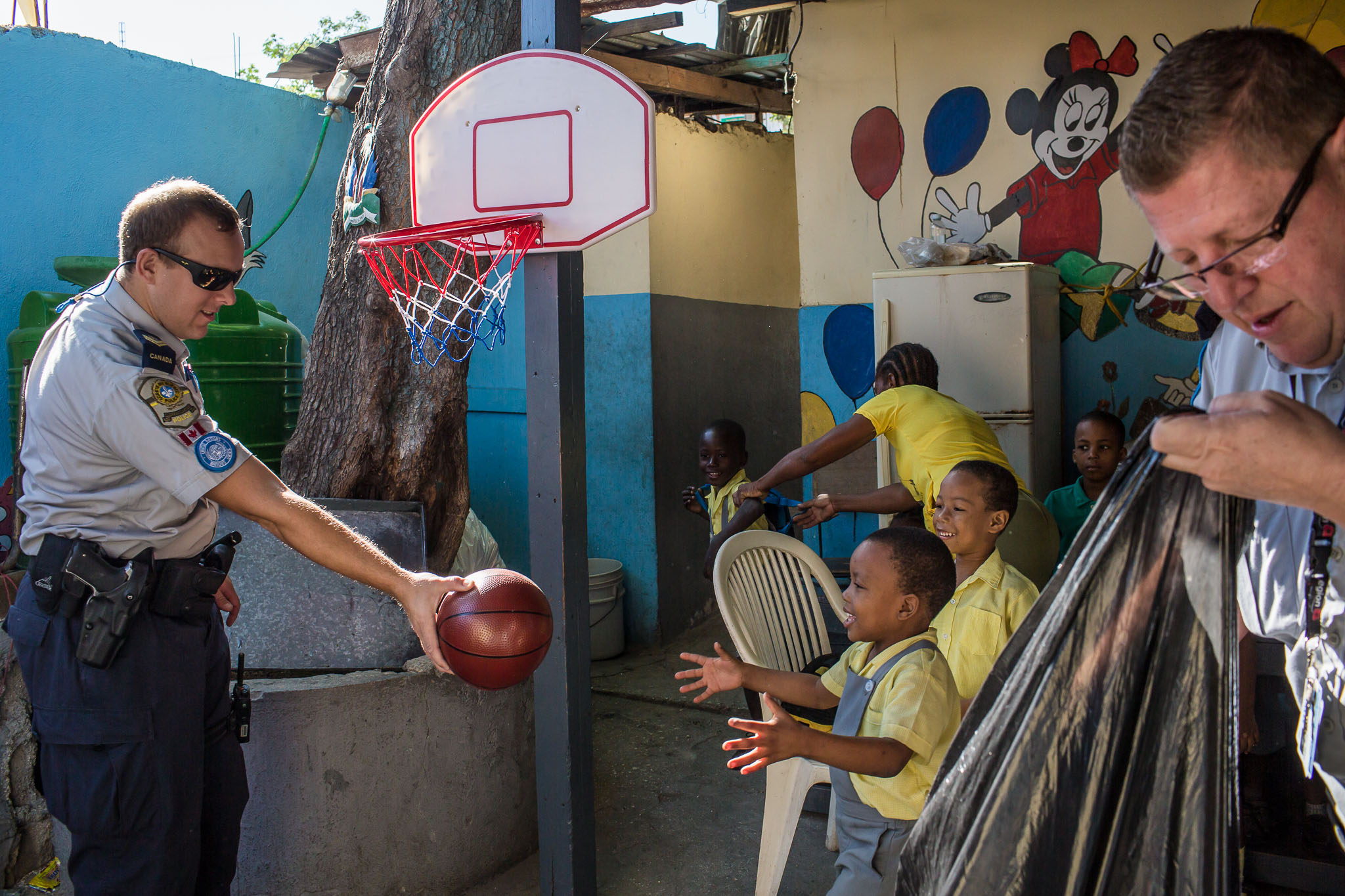  Simon Leblanc, left, and Robert Gagnon, police officers from Montreal, Canada, deliver toys and school supplies to students at Ecole Mixte Louis St. Juste in the Fort National neighborhood on Friday, December 19, 2014 in Port-au-Prince, Haiti. Thoug