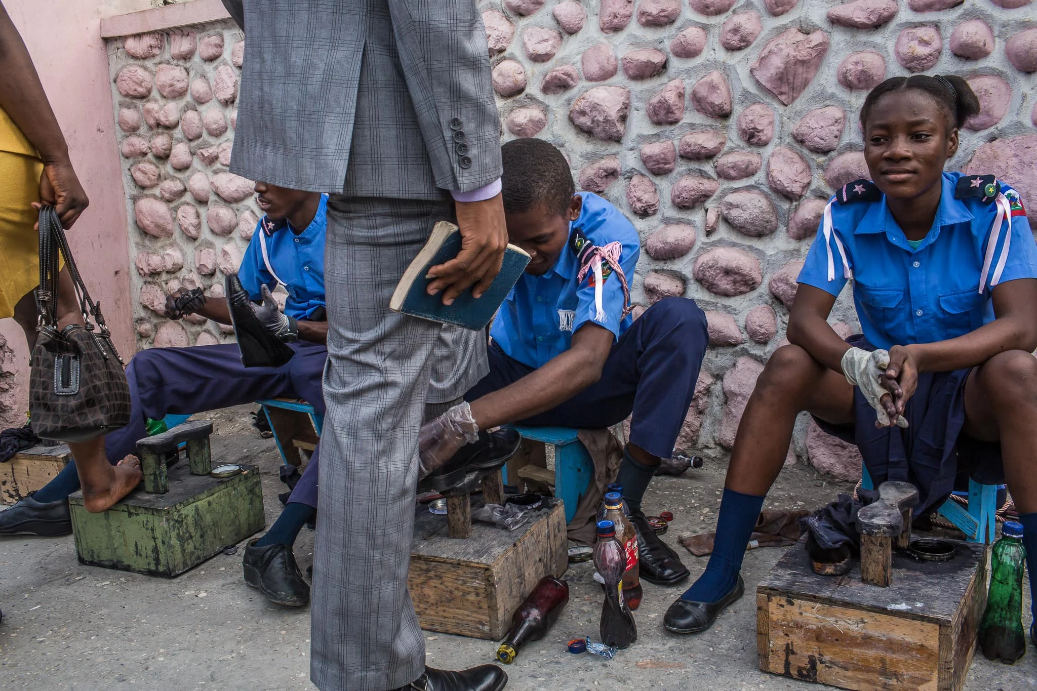 Children shine shoes to raise money for their church on Sunday, December 14, 2014 in Port-au-Prince, Haiti.