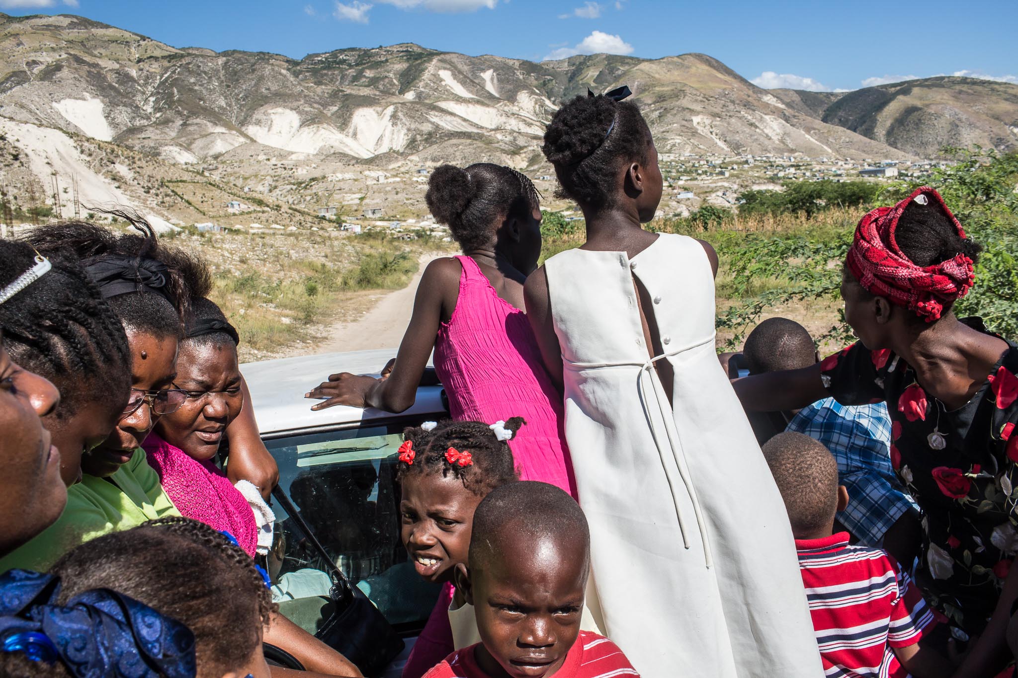  Worshipers catch a ride to their homes in the back of a pickup truck following services at Church of God for Fighting Pentecostal Church on the edge of the Corail-Cesselesse camp for people displaced by the 2010 earthquake on Sunday, December 21, 20