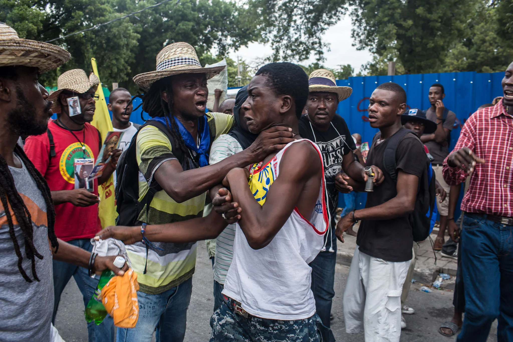 Anti-government protesters confront a pro-government man accused of stealing a cell phone on Tuesday, December 16, 2014 in Port-au-Prince, Haiti. President Michel Martelly was elected in 2010 with great hope for reforms, but in the wake of slow recovery and parliamentary elections that are three years overdue, his popularity has suffered tremendously, forcing Prime Minister Laurent Lamothe to resign.