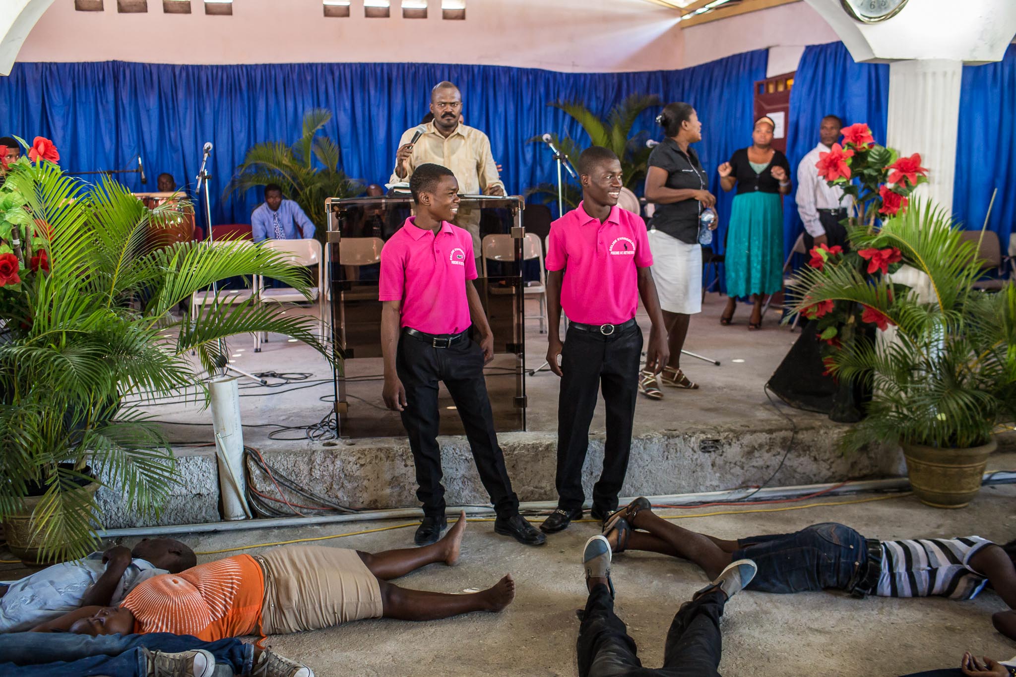  Ushers look over worshipers who have been overcome with religious fervor at L'Eglise Evangelique Piscine de Bethesda, the church of televangelist Marcorel Zidor, on Saturday, December 20, 2014 in Port-au-Prince, Haiti. Pastor Zidor attracts a large 