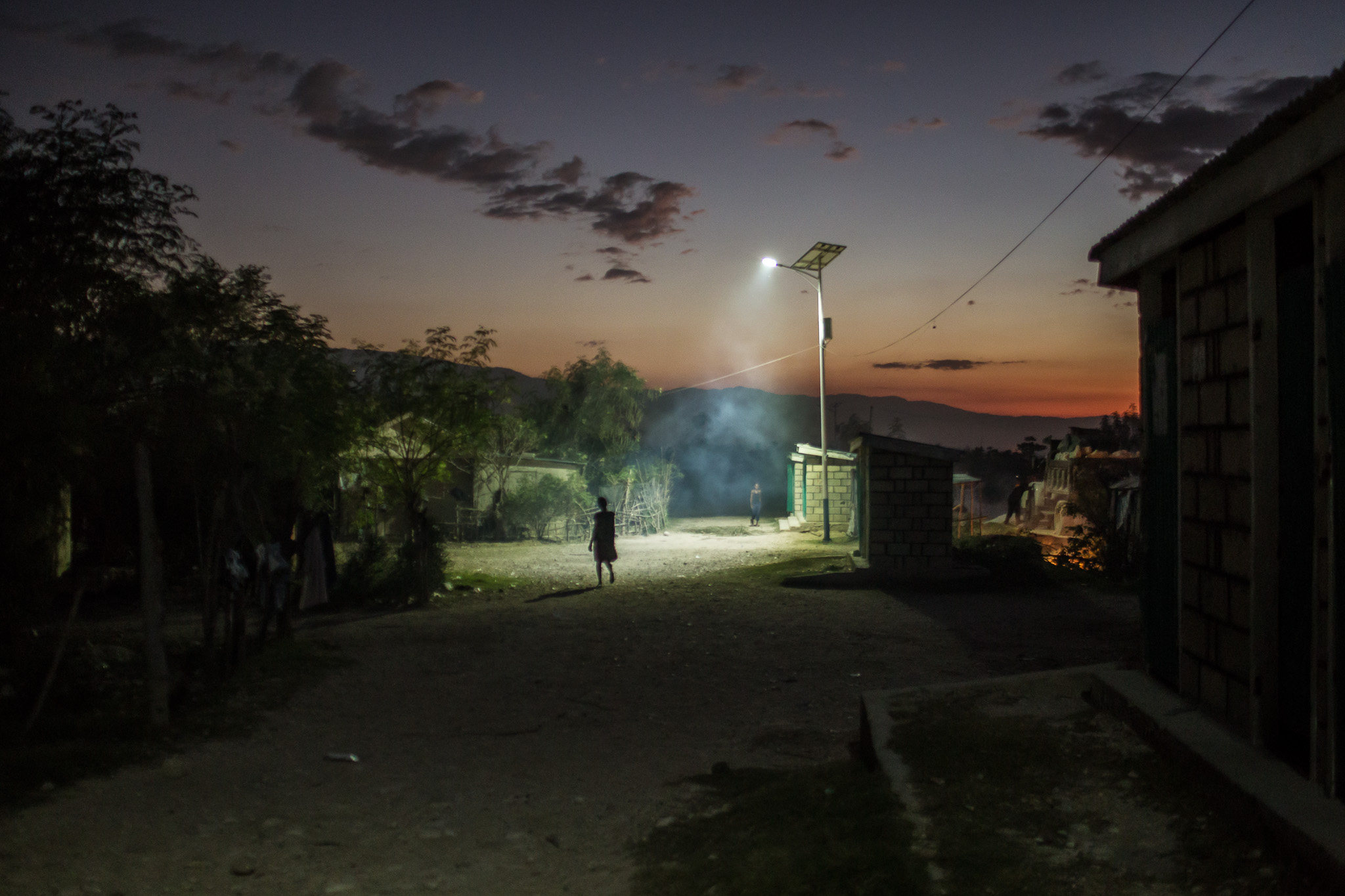  A solar-powered street light illuminates the Corail-Cesselesse camp for people displaced by the 2010 earthquake on Saturday, December 20, 2014 in Port-au-Prince, Haiti. The batteries for the lights are wearing out, and many do not last for more than