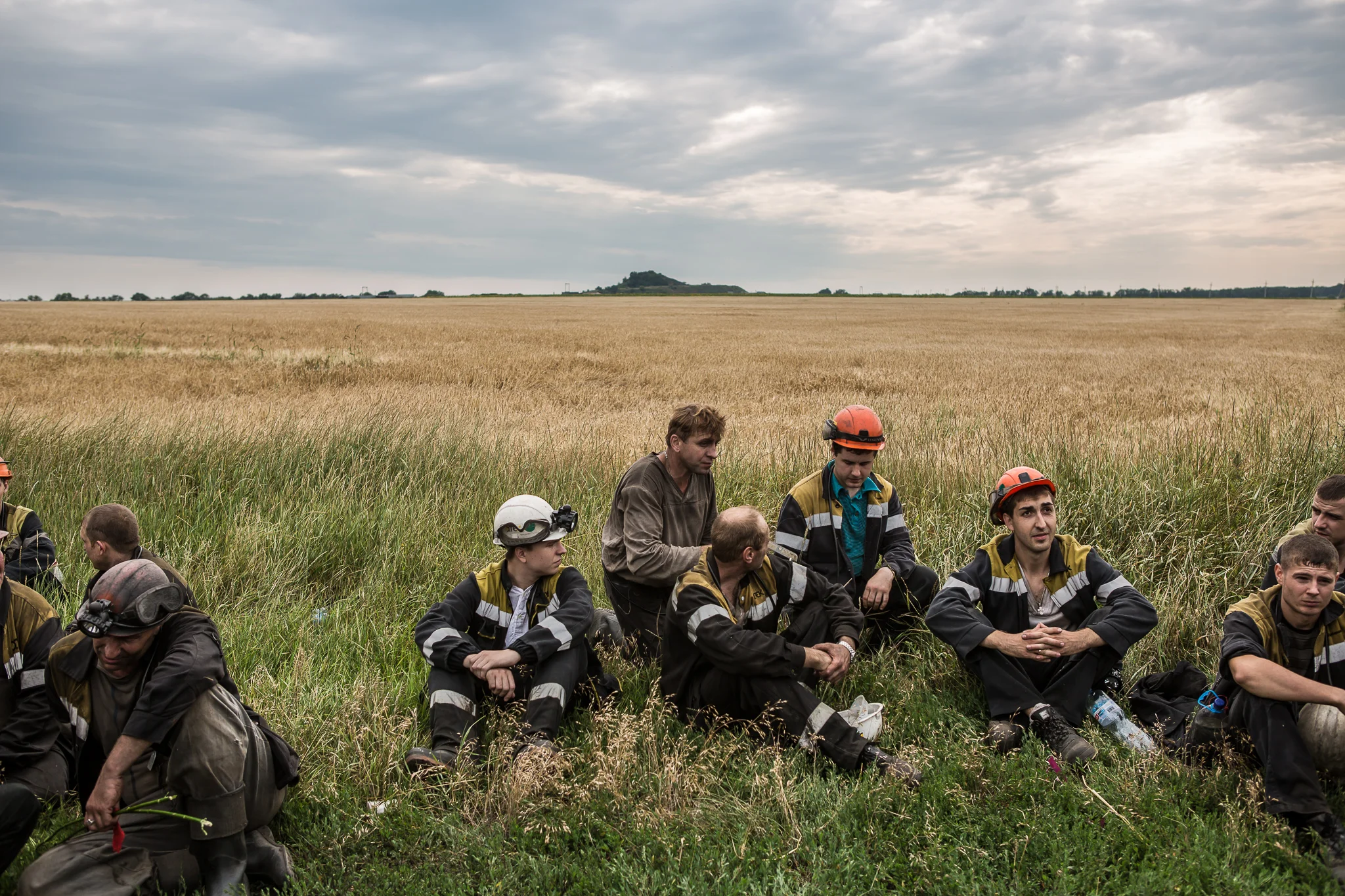 A group of coal miners takes a break after searching fields looking for remnants of Malaysia Airlines flight MH 17 on July 19, 2014 in Grabovo, Ukraine. Malaysia Airlines flight MH17 was travelling from Amsterdam to Kuala Lumpur when it crashed killing all 298 on board including 80 children. The aircraft was allegedly shot down by a missile and investigations continue over the perpetrators of the attack.