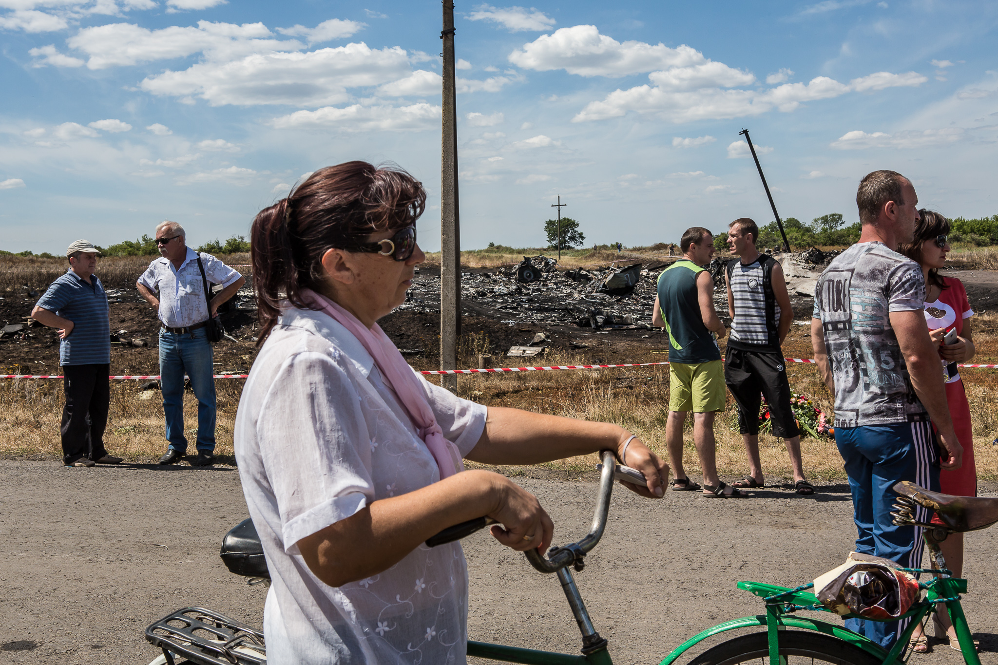  Local residents gather to watch as the bodies of victims of Malaysia Airlines flight MH17 are removed from the scene of the crash on July 21, 2014 in Grabovo, Ukraine. Malaysia Airlines flight MH17 was travelling from Amsterdam to Kuala Lumpur when 