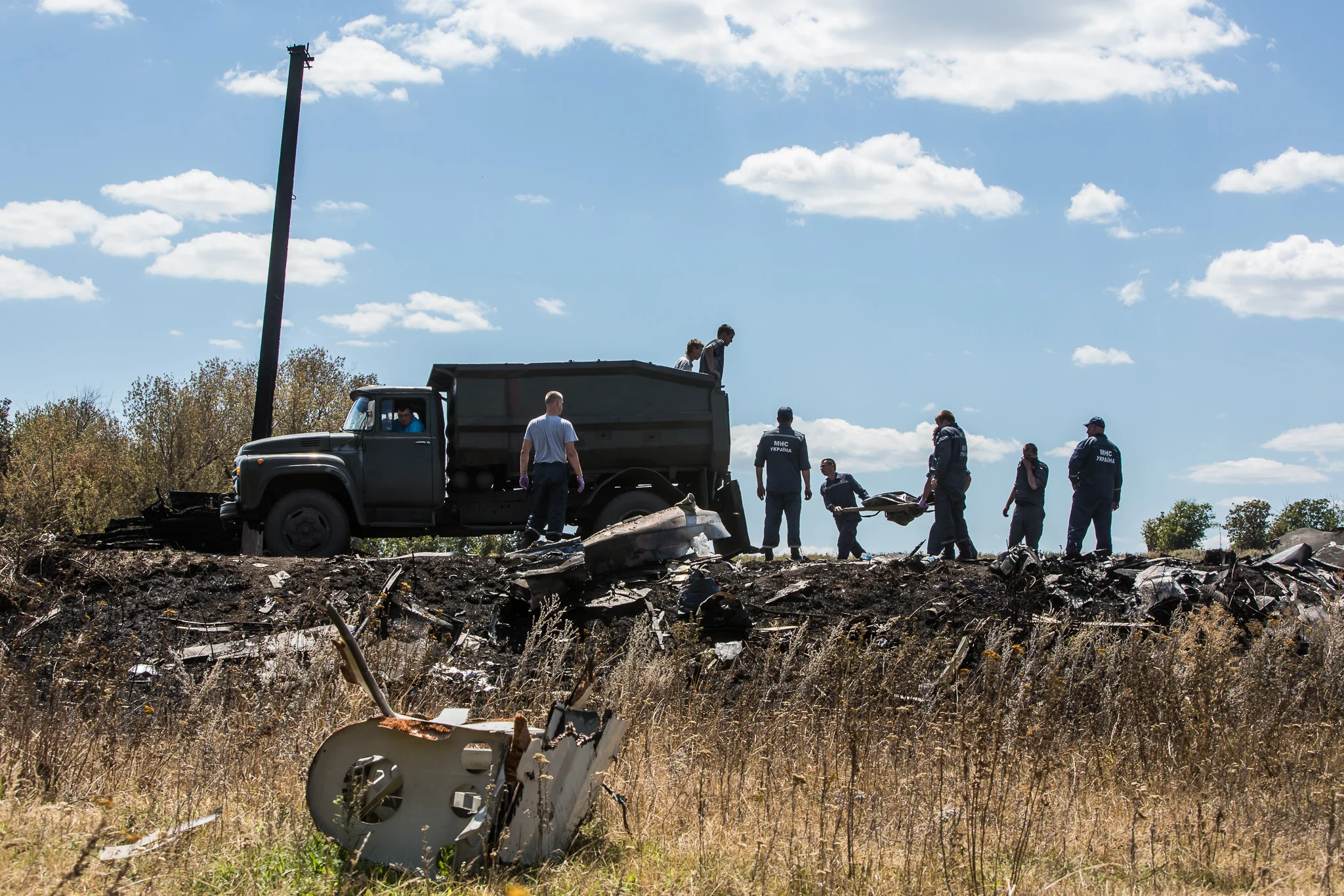 Personnel from the Ukrainian Emergencies Ministry load the bodies of victims of Malaysia Airlines flight MH17 into a truck at the crash site on July 21, 2014 in Grabovo, Ukraine. Malaysia Airlines flight MH17 was travelling from Amsterdam to Kuala Lumpur when it crashed killing all 298 on board including 80 children. The aircraft was allegedly shot down by a missile and investigations continue over the perpetrators of the attack.