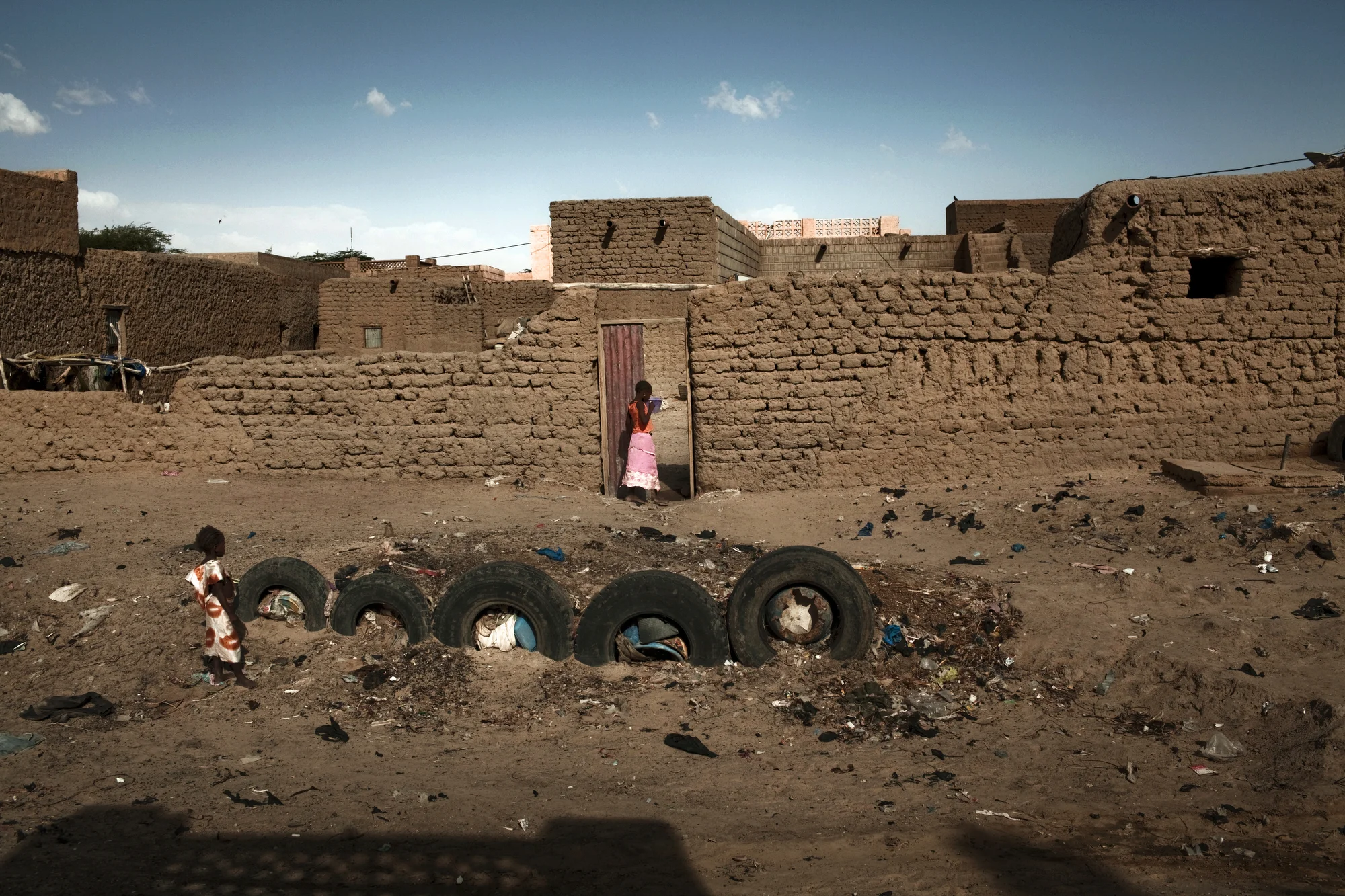 TIMBUKTU, Mali. OCTOBER 2013. Tires outside a home in Timbuktu, Mali, meant to protect against flooding. Timbuktu and much of Mali's northern towns still suffer from a lack of power, resources and food.
Summary: Mali, a predominantly Muslim country, has been known for it�s vibrant culture, rich ancient Islamic history, religious tolerance and joyful music and dance. Yet much of this culture was at risk of permanent destruction when militant Islamist rebels took over Northern Mali in 2012. The rebels imposed their own despotic version of religious Islamic law and women bore the brunt of the crackdown. Many women fled, while some remained in the confines of their homes for over a year. In the spring of 2013 the French army entered Mali and defeated the Islamist militias. Photo by Katie Orlinsky.