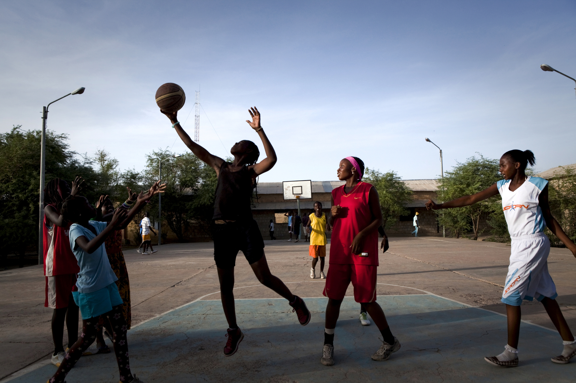  TIMBUKTU, Mali. OCTOBER 2013. Girls play basketball in downtown Timbuktu, Mali, as part of the Academie de Basket coached by El Hadj Adjanga, a 54-year-old local butcher.  "I can tell you this..the first week after liberation -- as soon as they coul