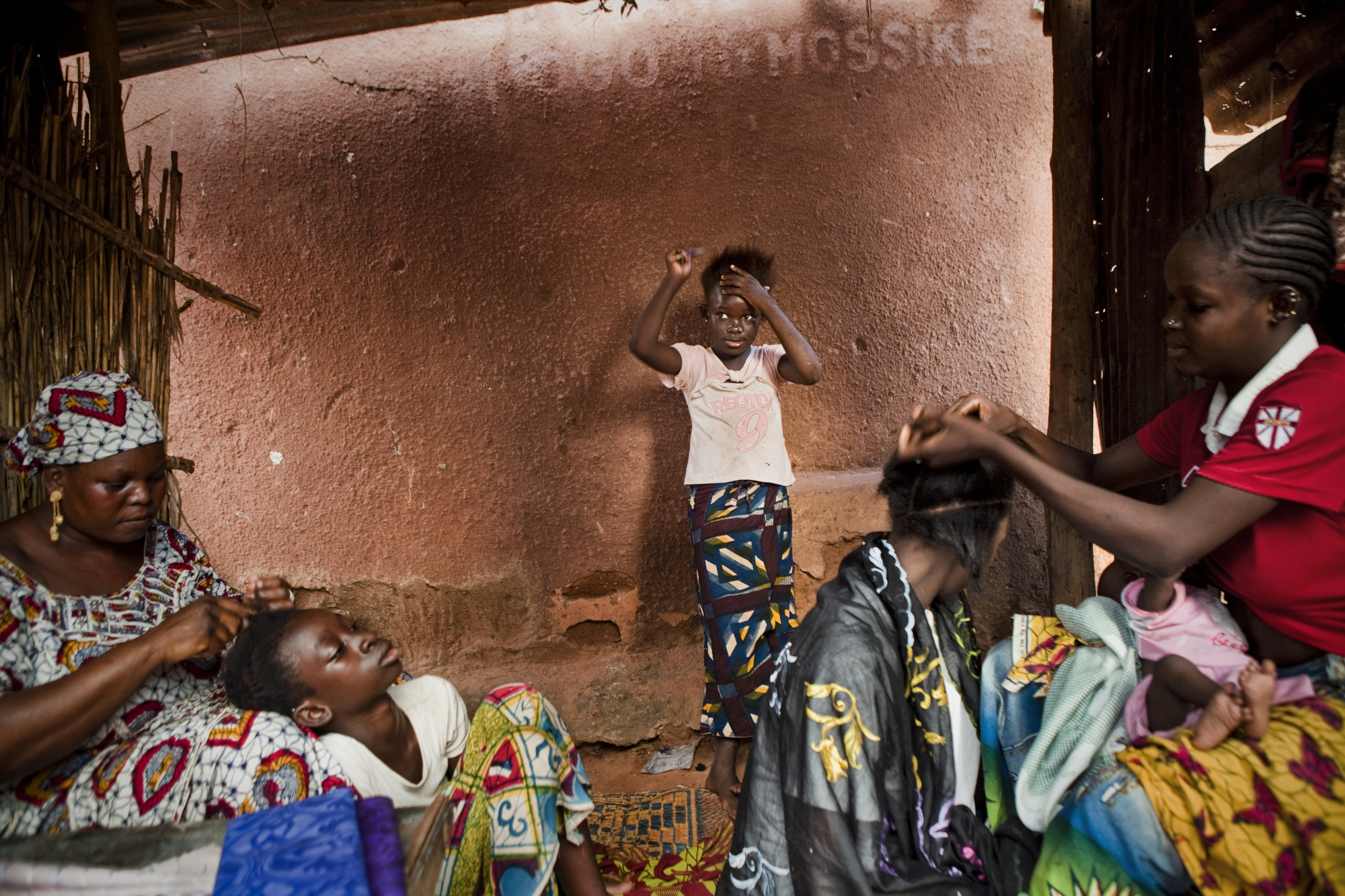  Bamako, Mali. SEPTEMBER 2013. An outdoor hair salon in a shack in Bamako, Mali. 

Summary: Mali, a predominantly Muslim country, has been known for it�s vibrant culture, rich ancient Islamic history, religious tolerance and joyful music and dance. Y