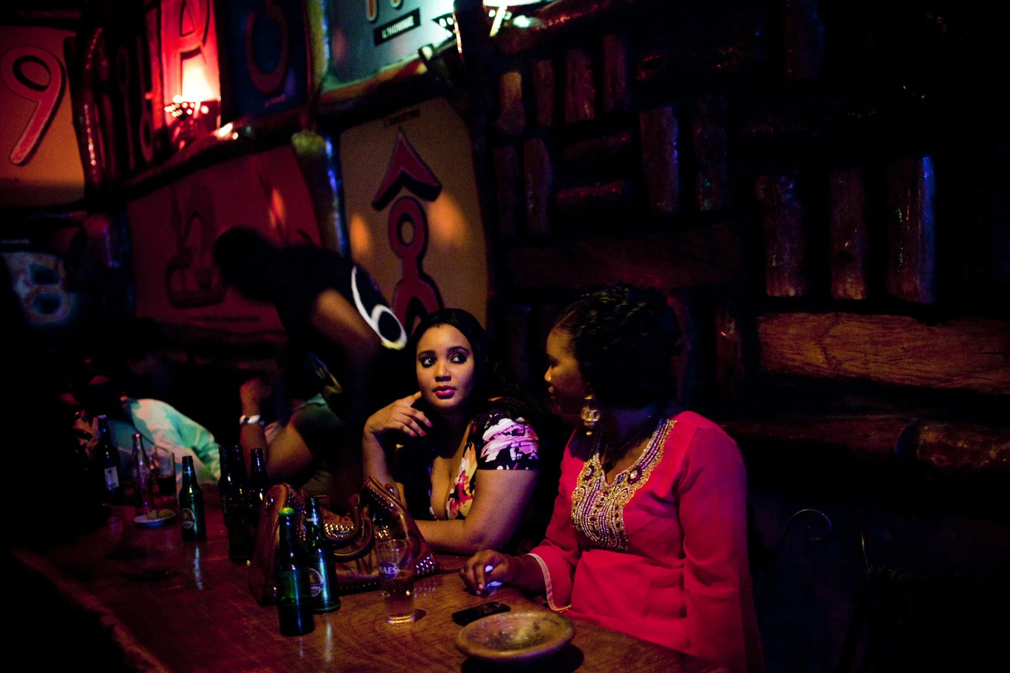 Women at a bar in Bamako, Mali. A combination of fear after the 2012 conflict and a a rising conservative Islamist wave in Malian society has led to the shuttering of many establishments that serve alcohol, even in the capital.
Summary: Mali, a predominantly Muslim country, has been known for it�s vibrant culture, rich ancient Islamic history, religious tolerance and joyful music and dance. Yet much of this culture was at risk of permanent destruction when militant Islamist rebels took over Northern Mali in 2012. The rebels imposed their own despotic version of religious Islamic law and women bore the brunt of the crackdown. Many women fled, while some remained in the confines of their homes for over a year. In the spring of 2013 the French army entered Mali and defeated the Islamist militias. Photo by Katie Orlinsky.